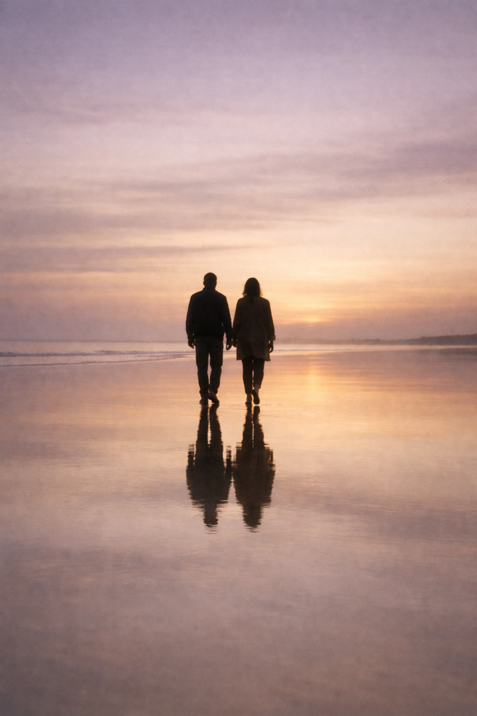 Two people walking on a peaceful beach symbolizing a healthy relationship after transformation.