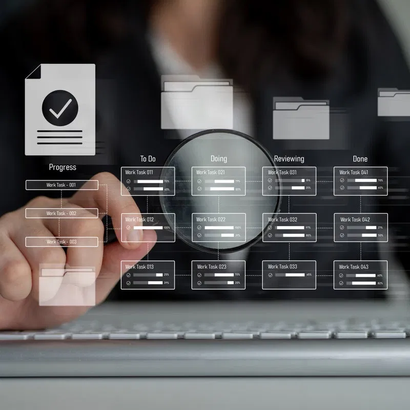 Using a magnifying glass to focus on specific tasks on a project board