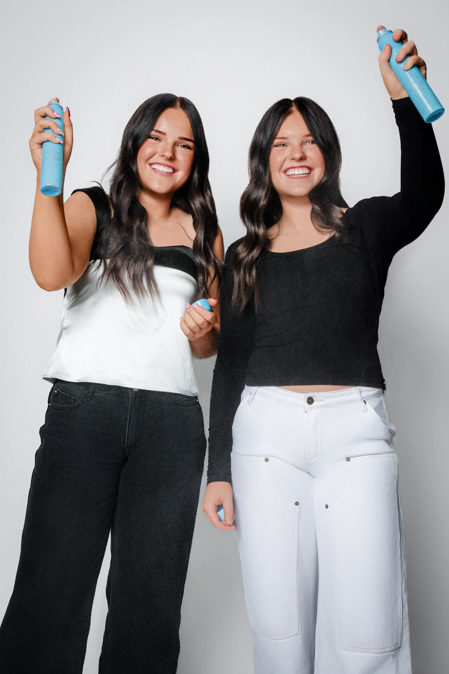 shine-duo-two-women-smiling-blue-hair-spray-bottles.webp