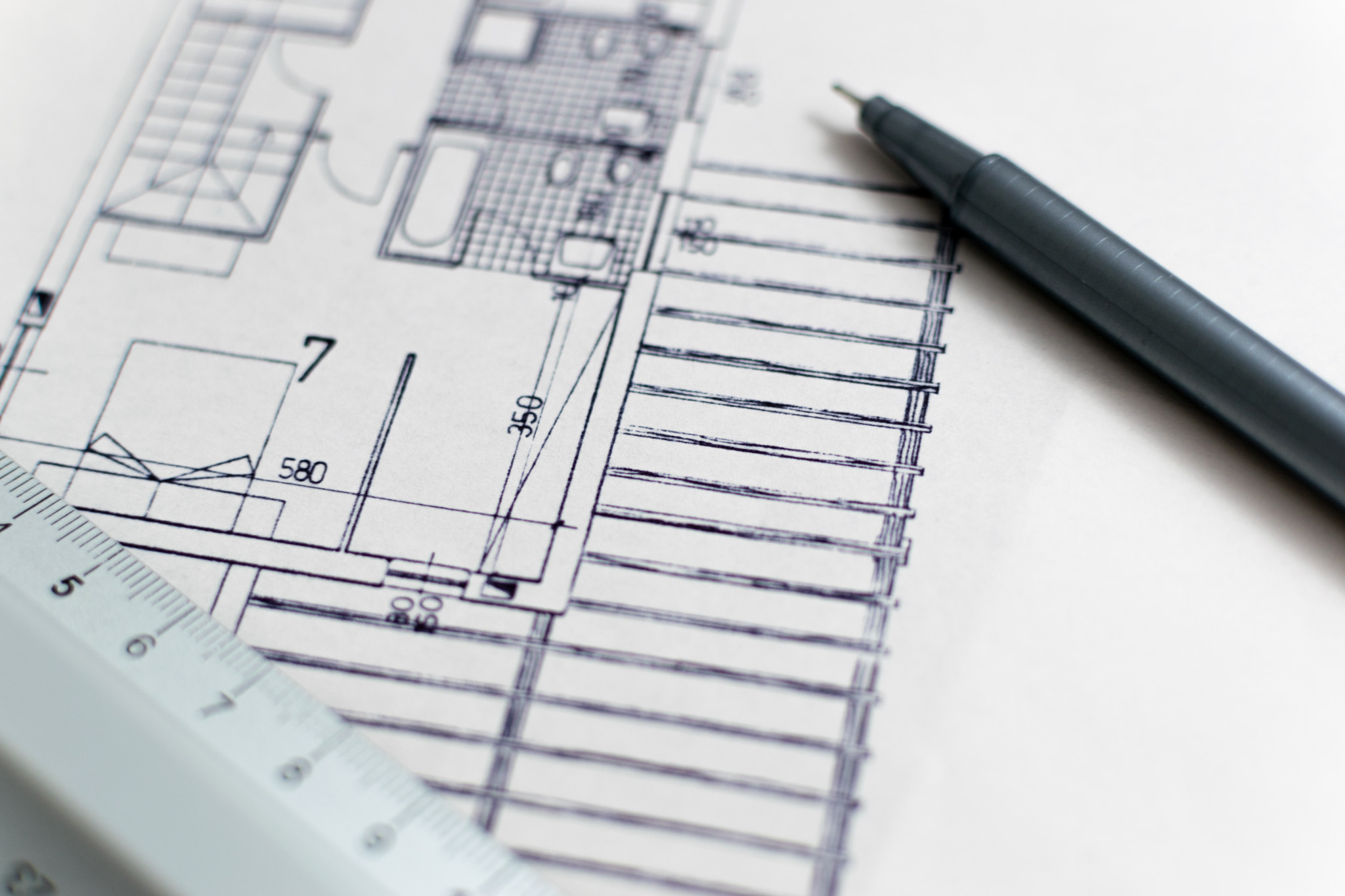 A close-up image of a construction site plan featuring detailed architectural drawings and measurements