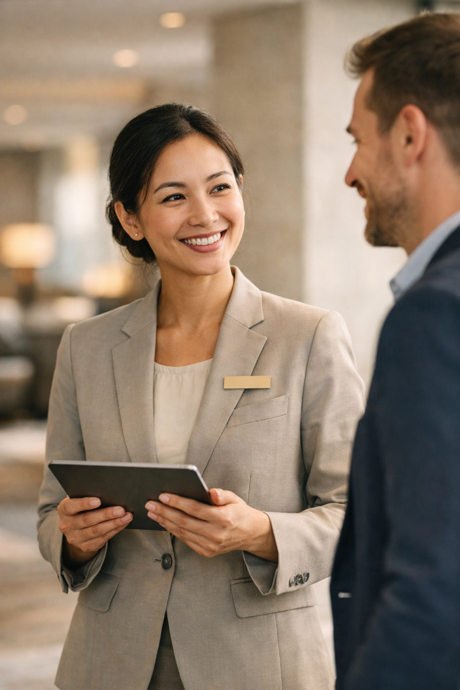 Hotel staff using automated software to improve the guest experience in a lobby.