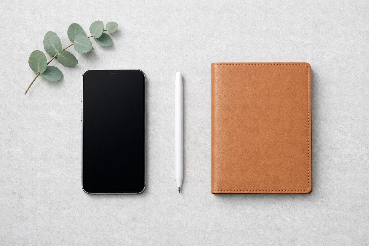 A minimalist flat-lay of mobile devices representing a smooth hotel PMS and CRM integration process.