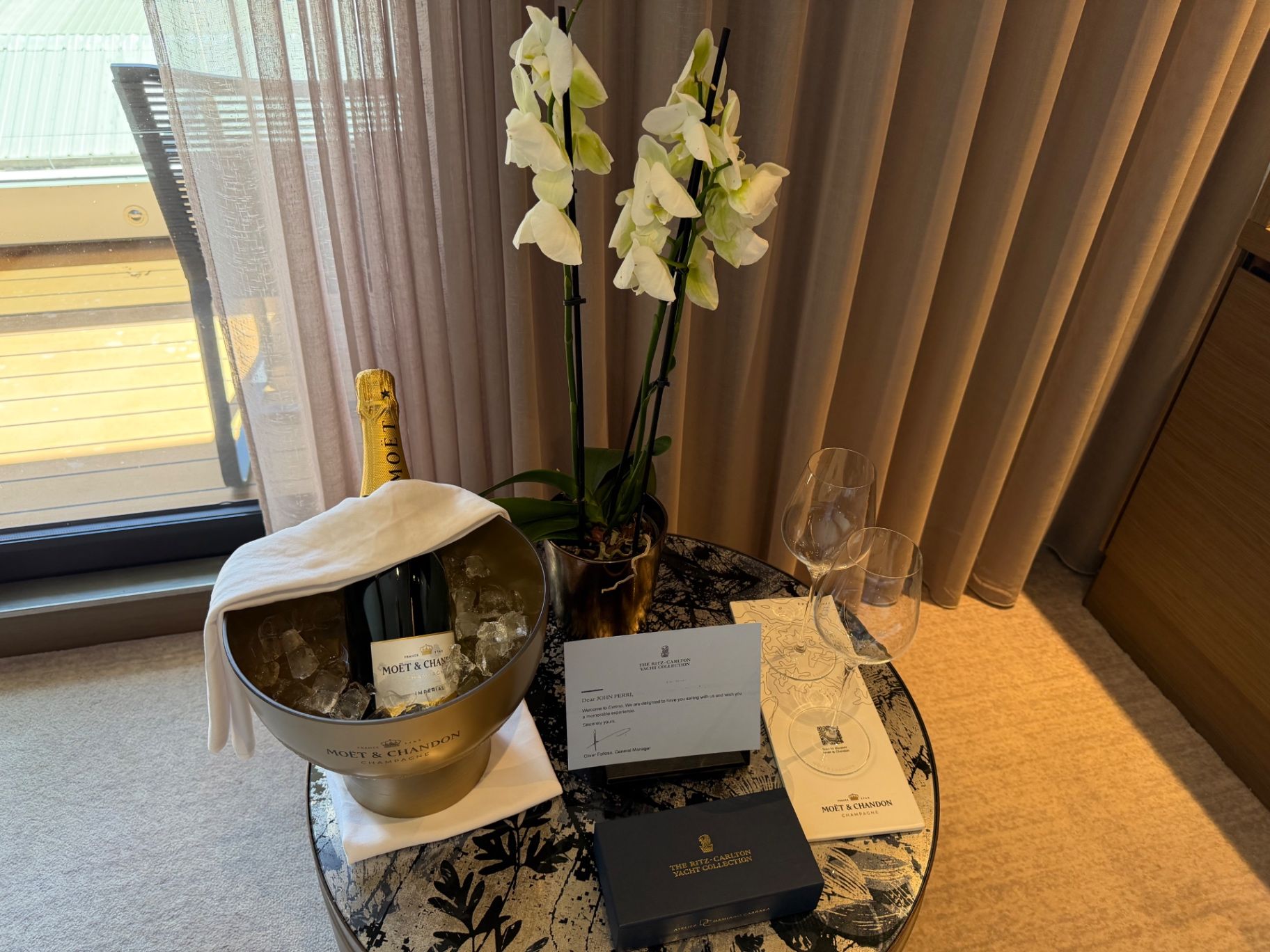 a table with a bottle of wine and flowers