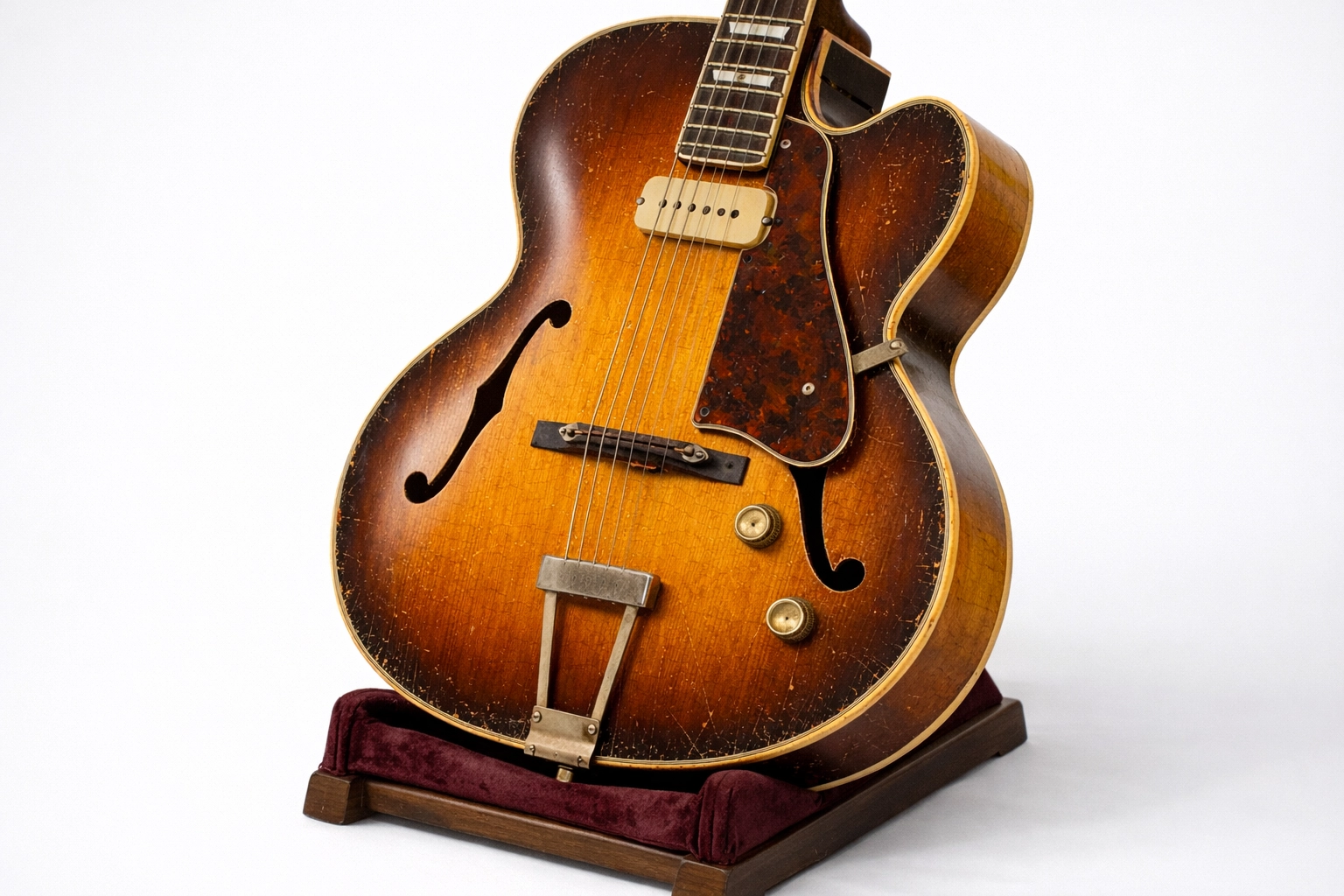 Vintage archtop guitar in sunburst finish showing original condition and wear for collector appraisal
