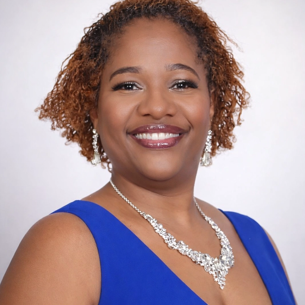 Ananeika Gordon, Founder & CEO of Family ReBuild of New Jersey, professional headshot in a royal blue dress.