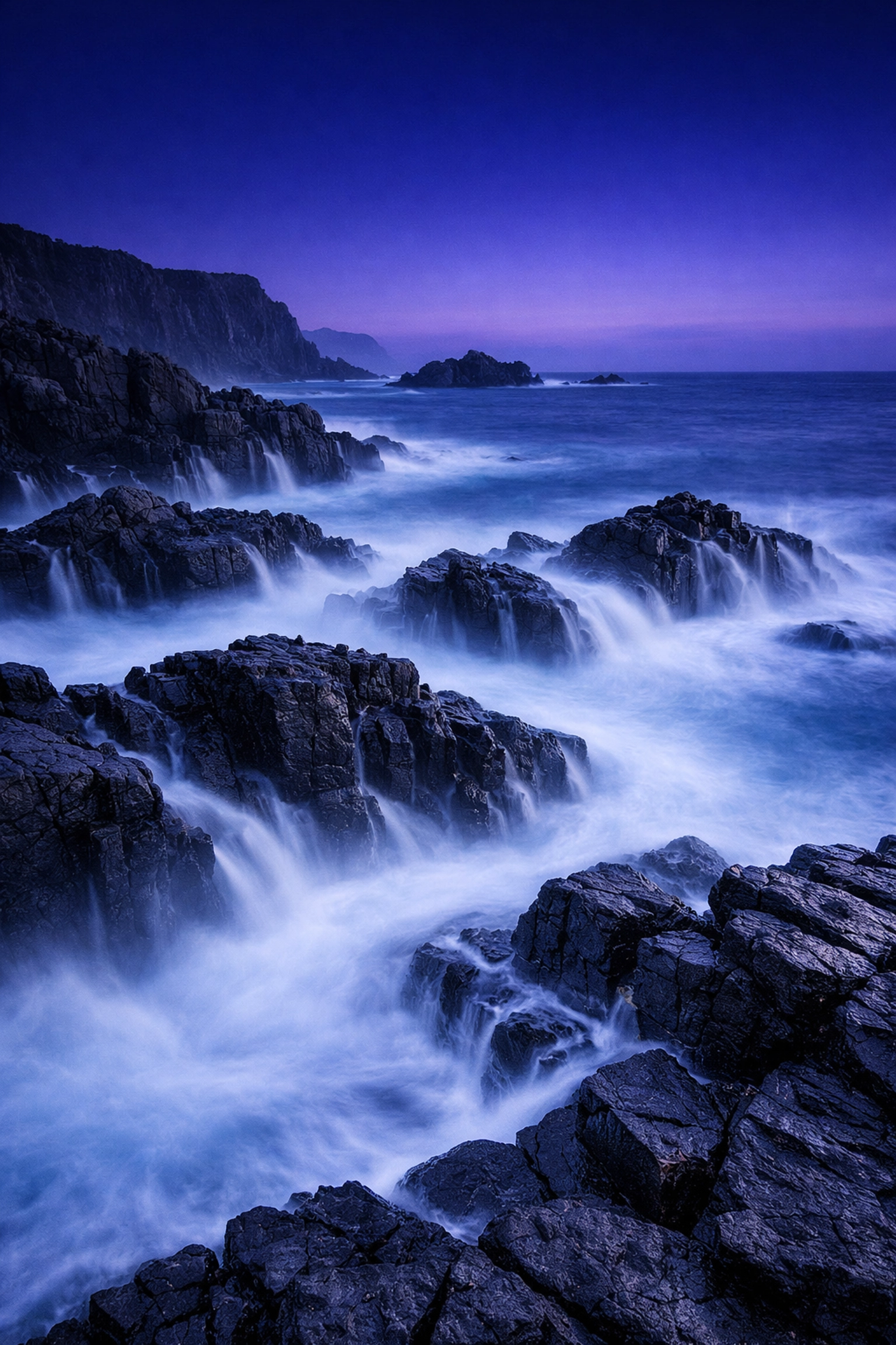 Long exposure coastal landscape with misty water, showing creative shutter speed control in manual mode.
