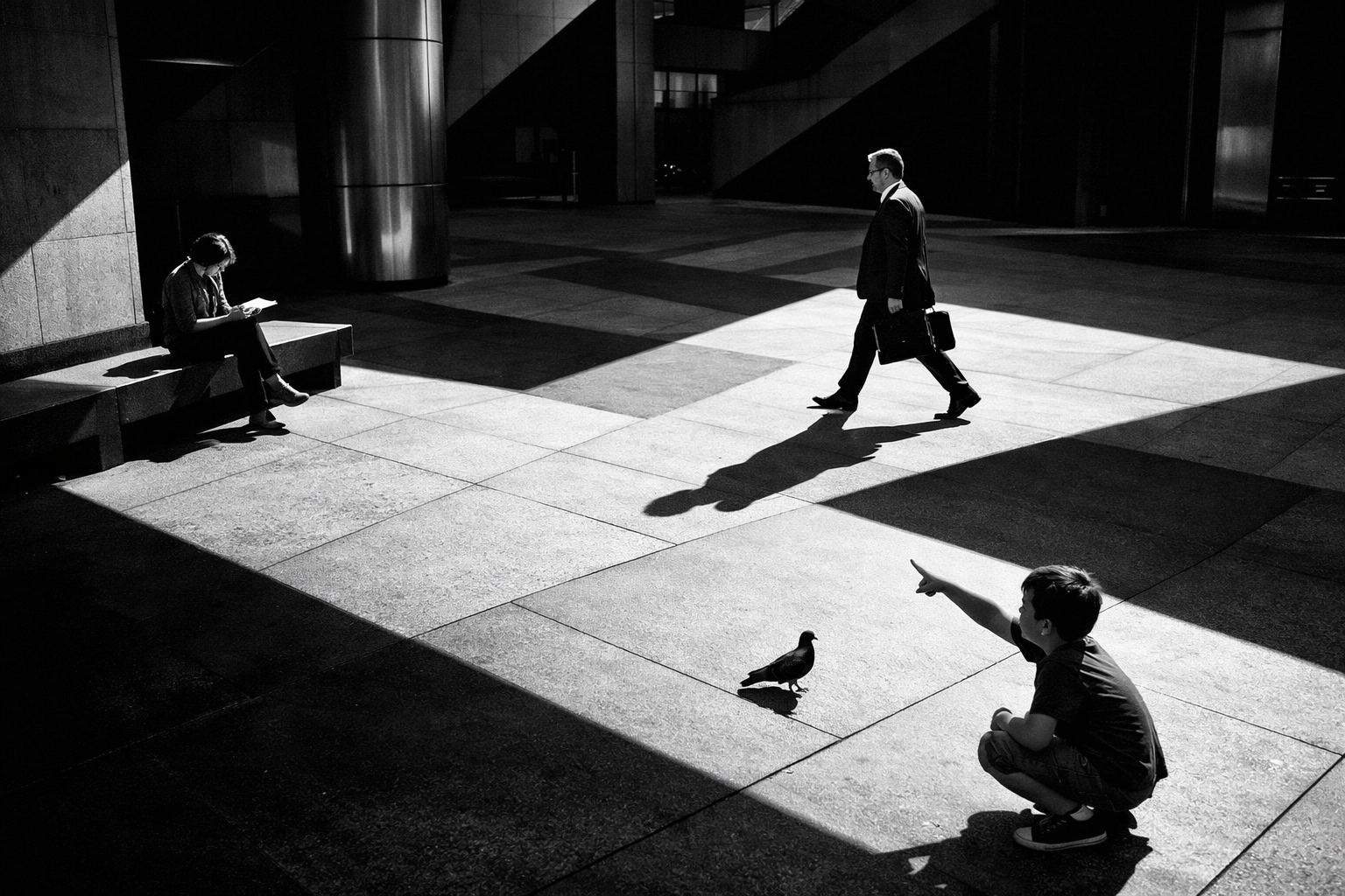 High-contrast black and white shot of three people in a plaza, illustrating creative street photography ideas for composition.