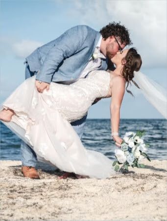 bride-groom-kissing-beach-wedding.jpeg