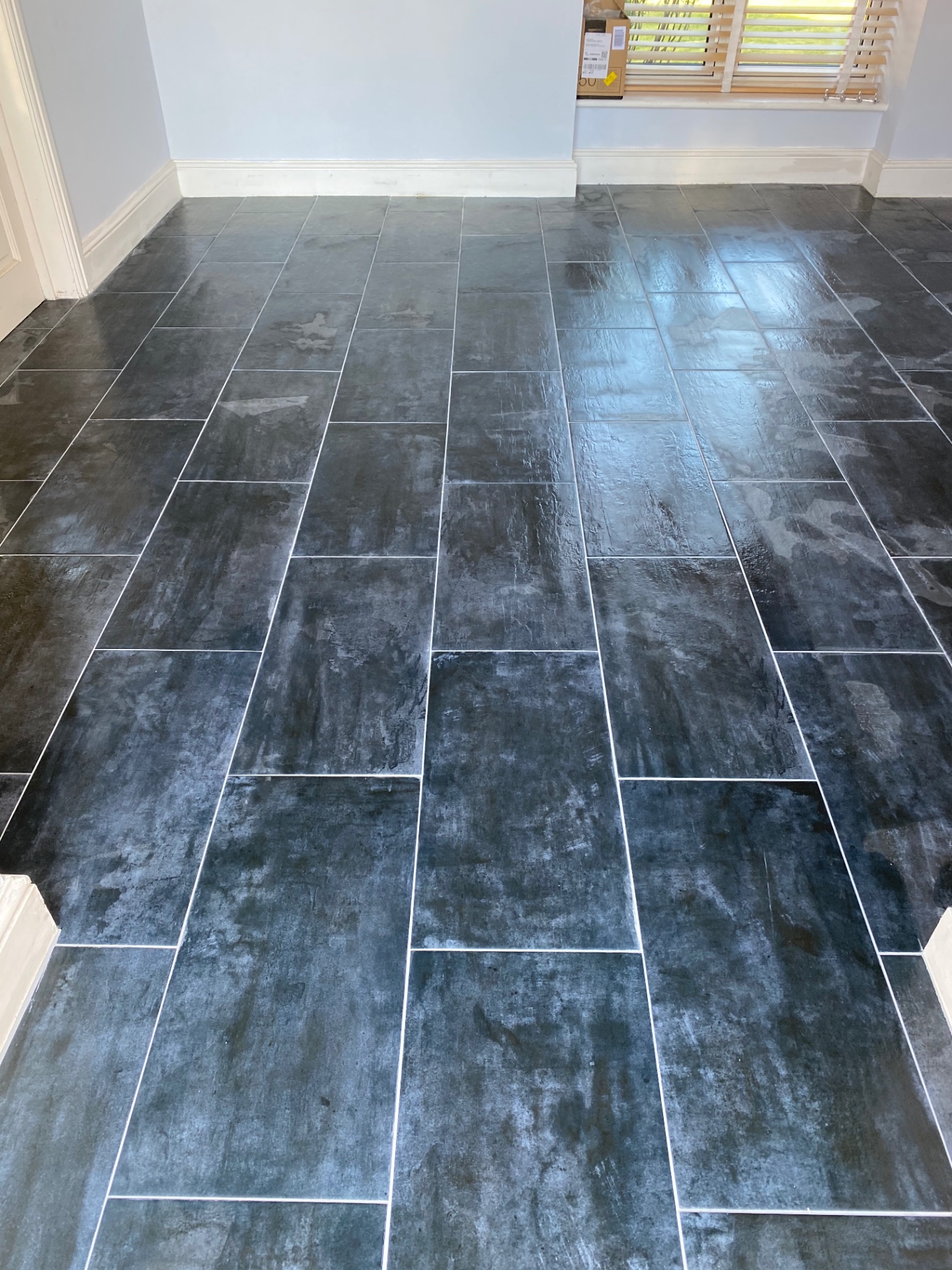 Newly installed dark slate effect floor tiles