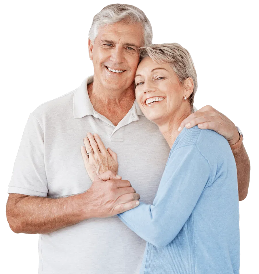 A smiling older couple stands together, looking relaxed and happy, representing business owners who have successfully transitioned to retirement after selling their business.