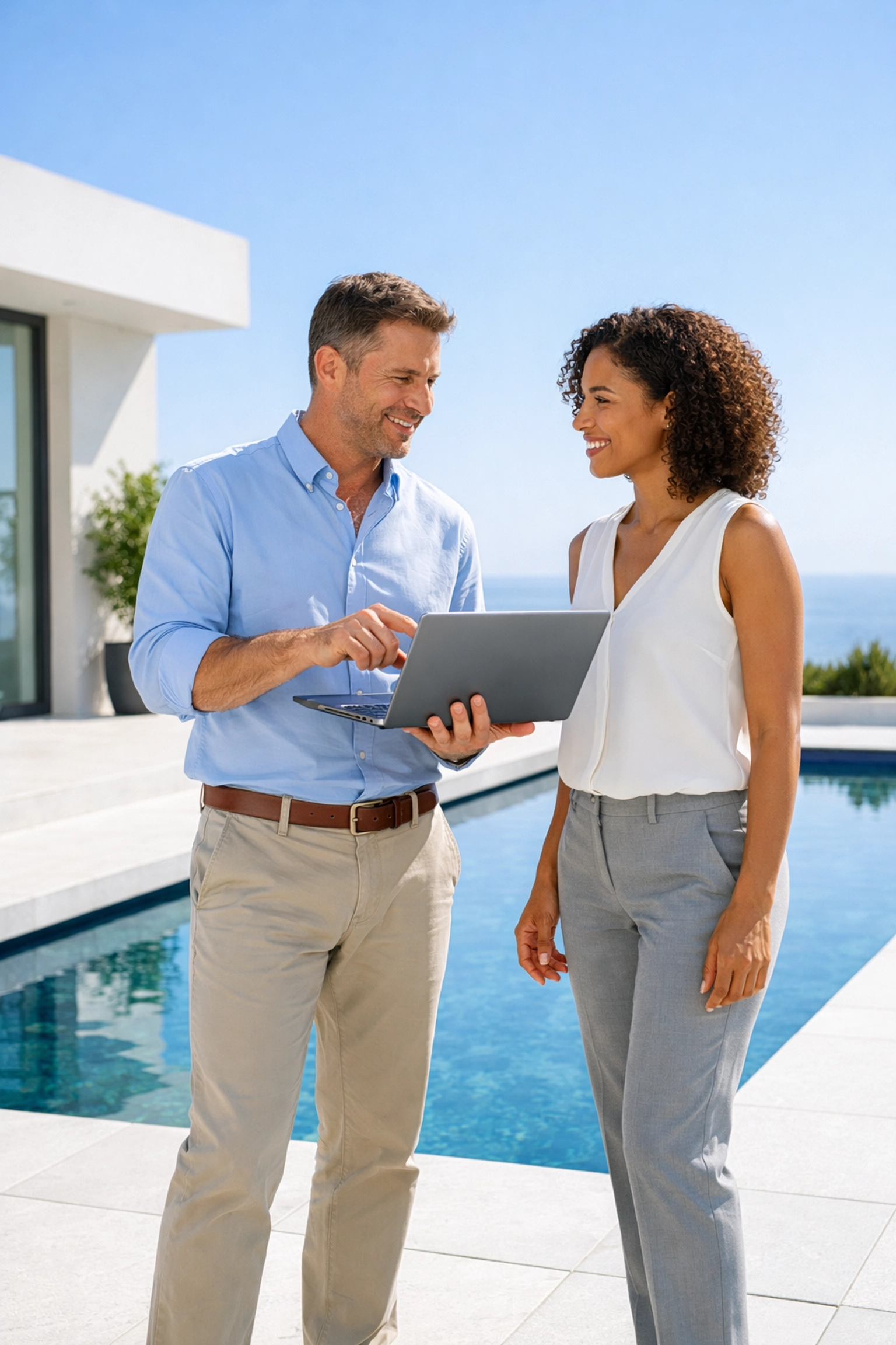 Business brokers vetting a qualified buyer for a pool route sale on a modern white stone patio.