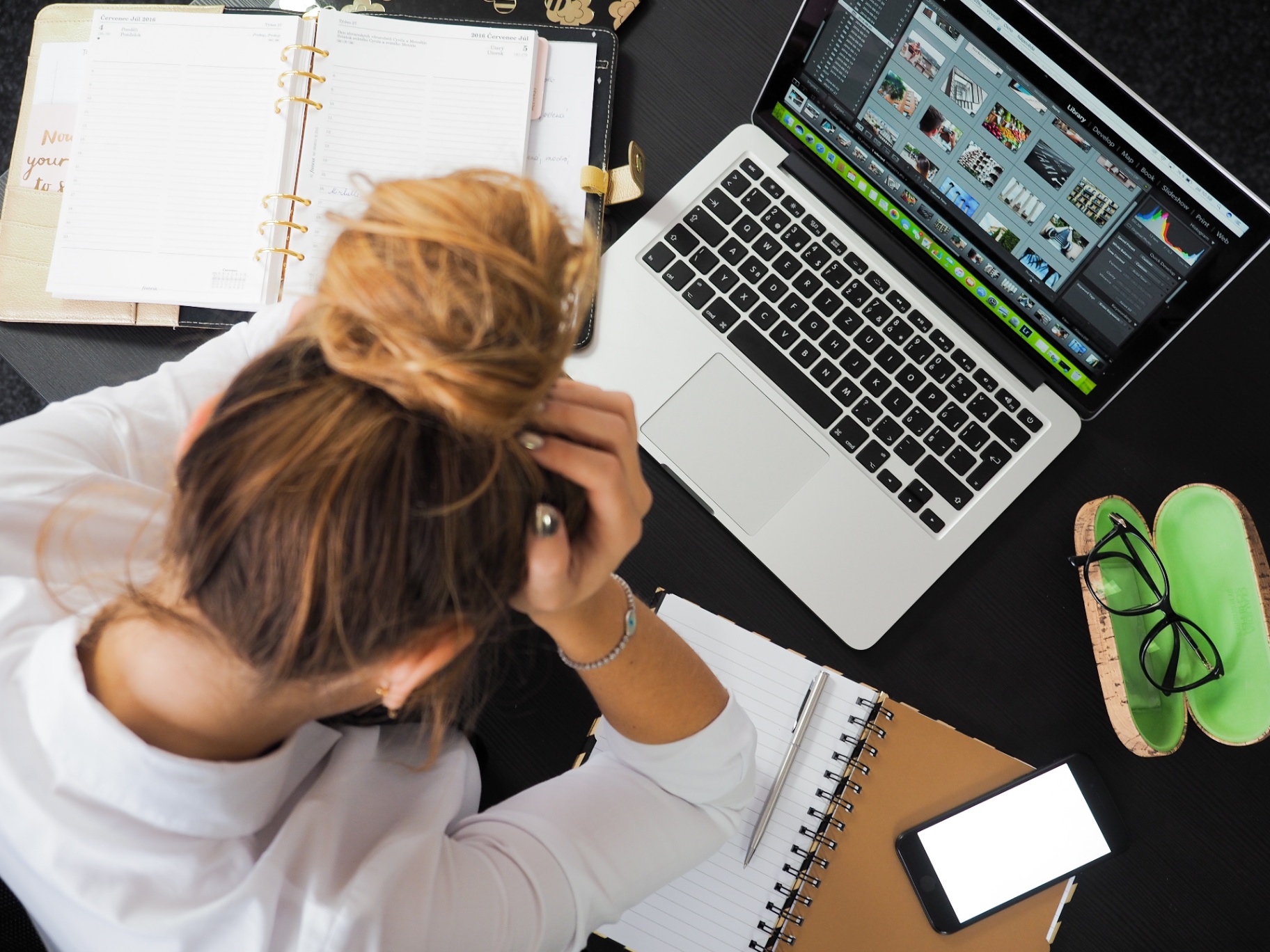 Stressed business professional at cluttered desk
