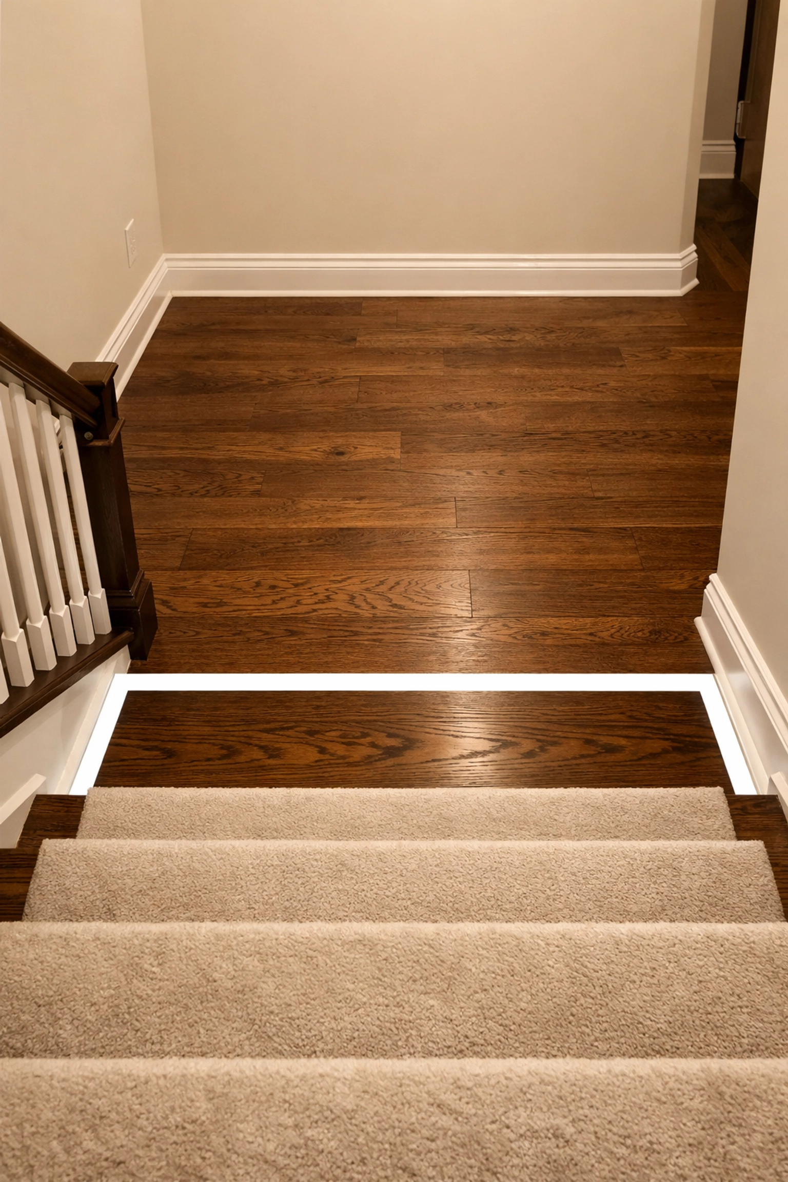 High-contrast white border on the bottom step of a staircase to prevent tripping illusions.