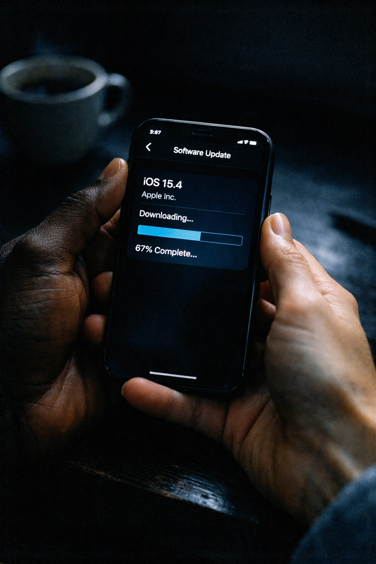 iPhone displaying iOS software update screen with download progress for device maintenance