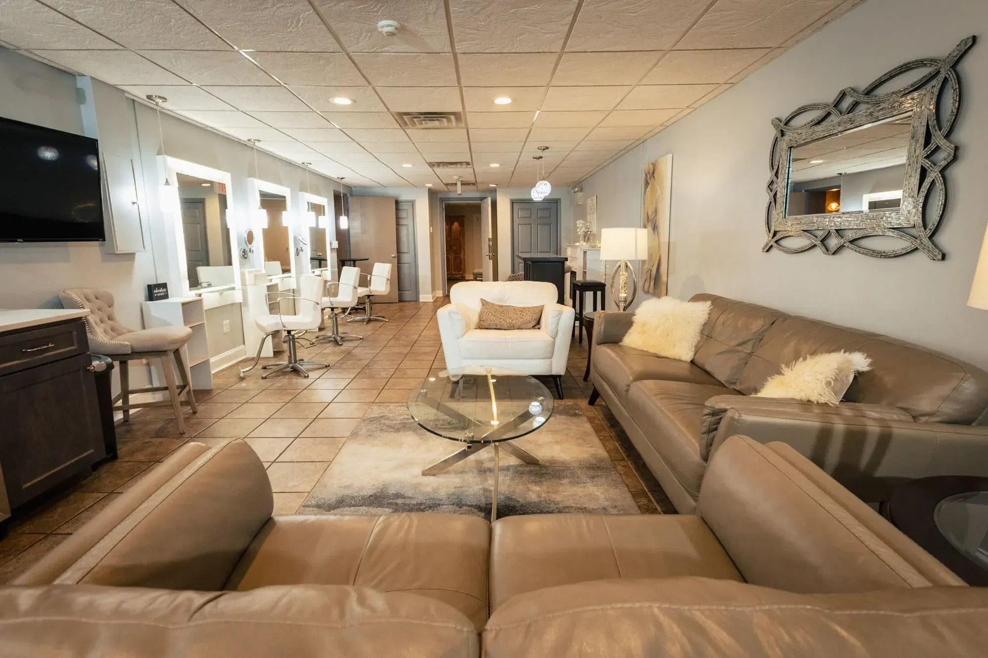Close-up of a modern bridal lounge area with stylish mirrors and plush seating
