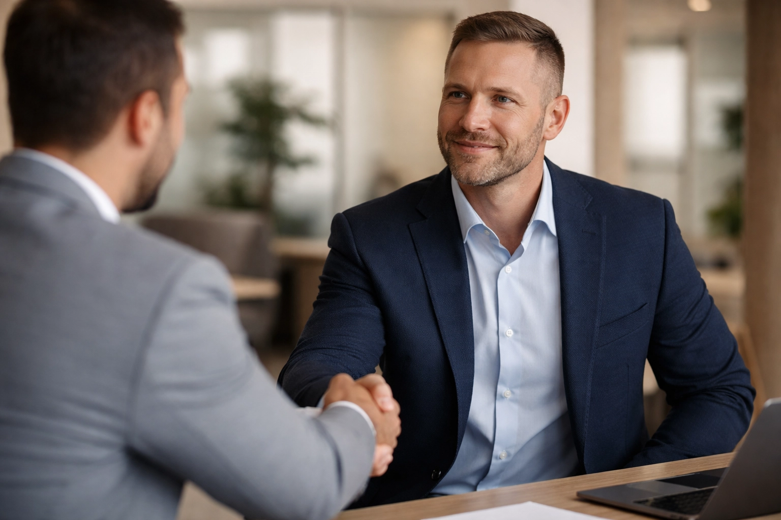 Veteran in business attire working at a modern desk, planning a confident career transition to civilian jobs.