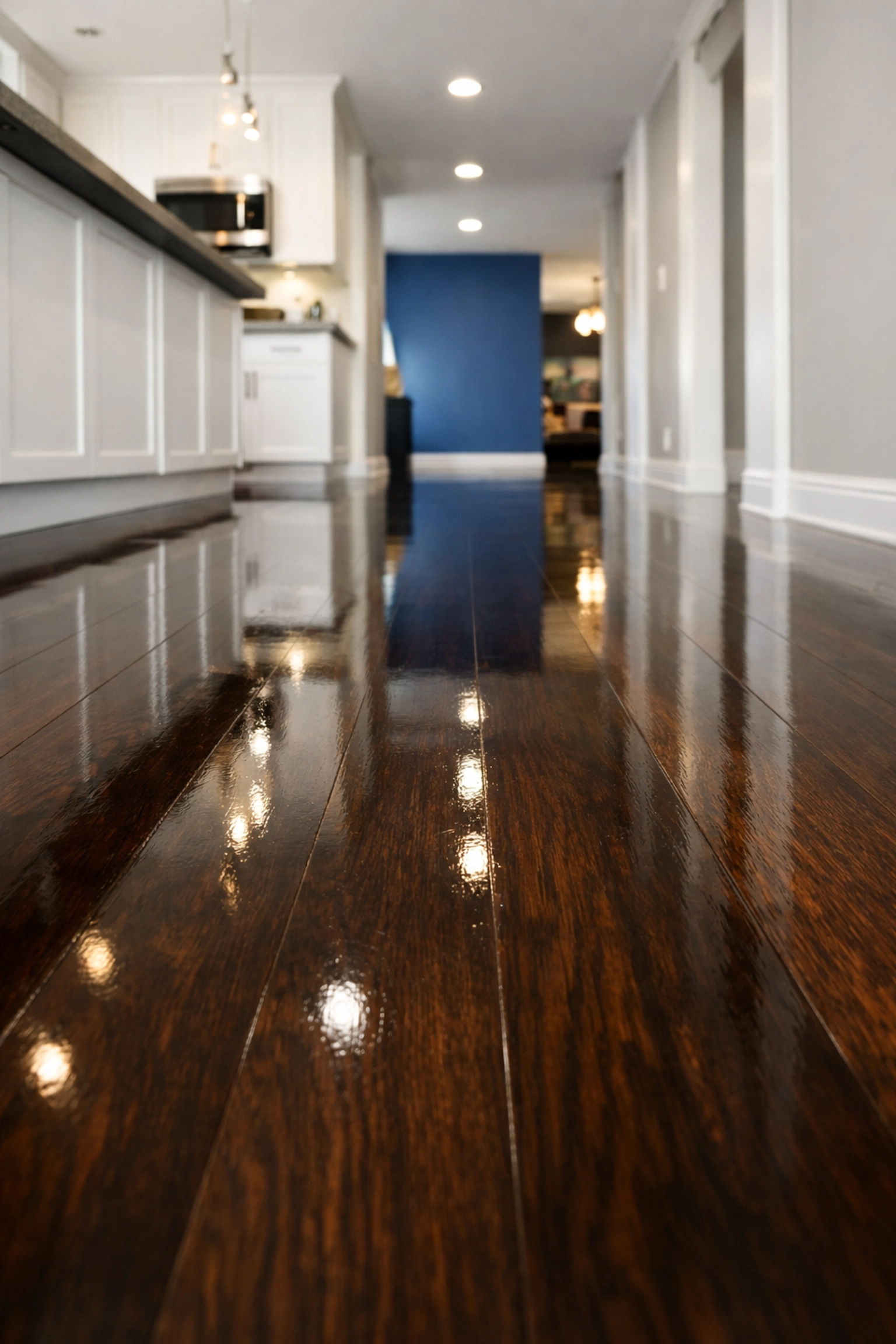 Spotless dark-stained hardwood floors with a mirror-like finish from a deep cleaning Marlborough session.