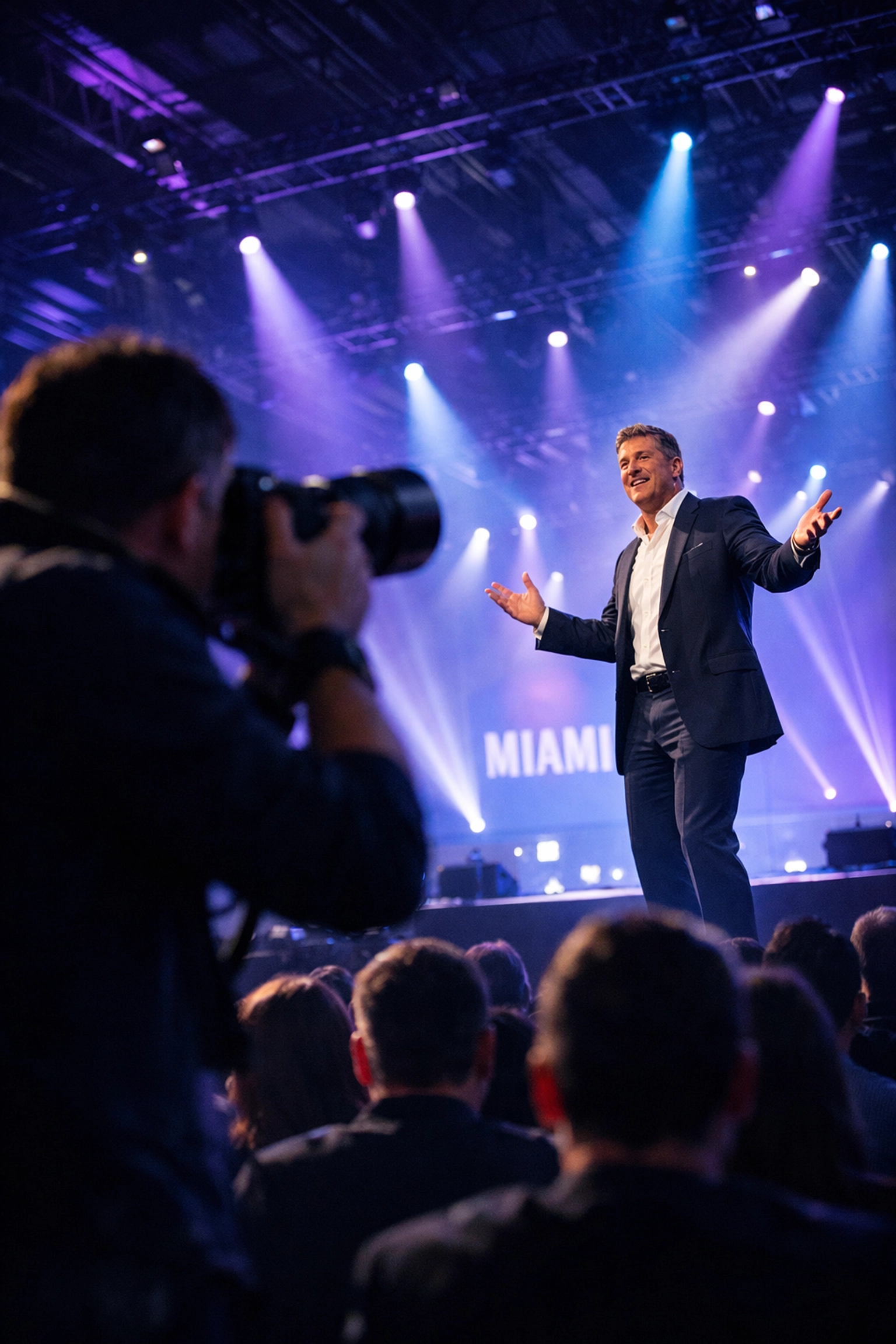 Professional conference photographer capturing a dynamic keynote speaker at a major Miami event venue.