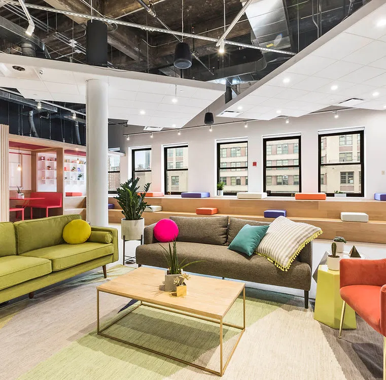 A bright modern office lounge designed for team collaboration and candidate interviews