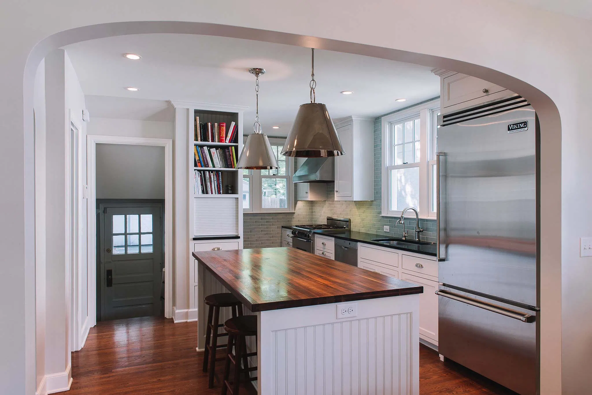 Custom-designed kitchen featuring a central island and integrated bookshelves.