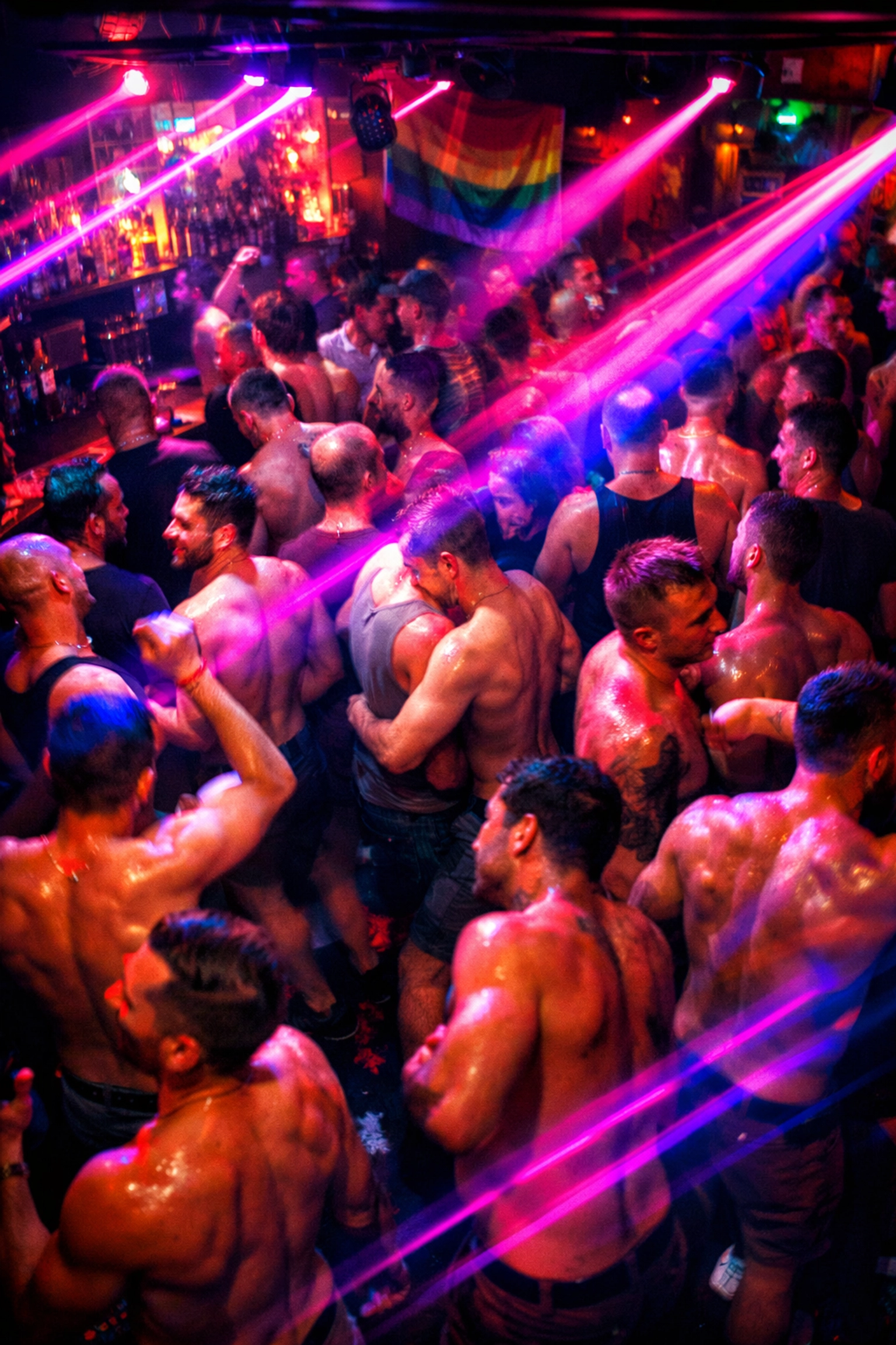 Men dancing on crowded dance floor under neon lights in LGBTQ+ nightclub