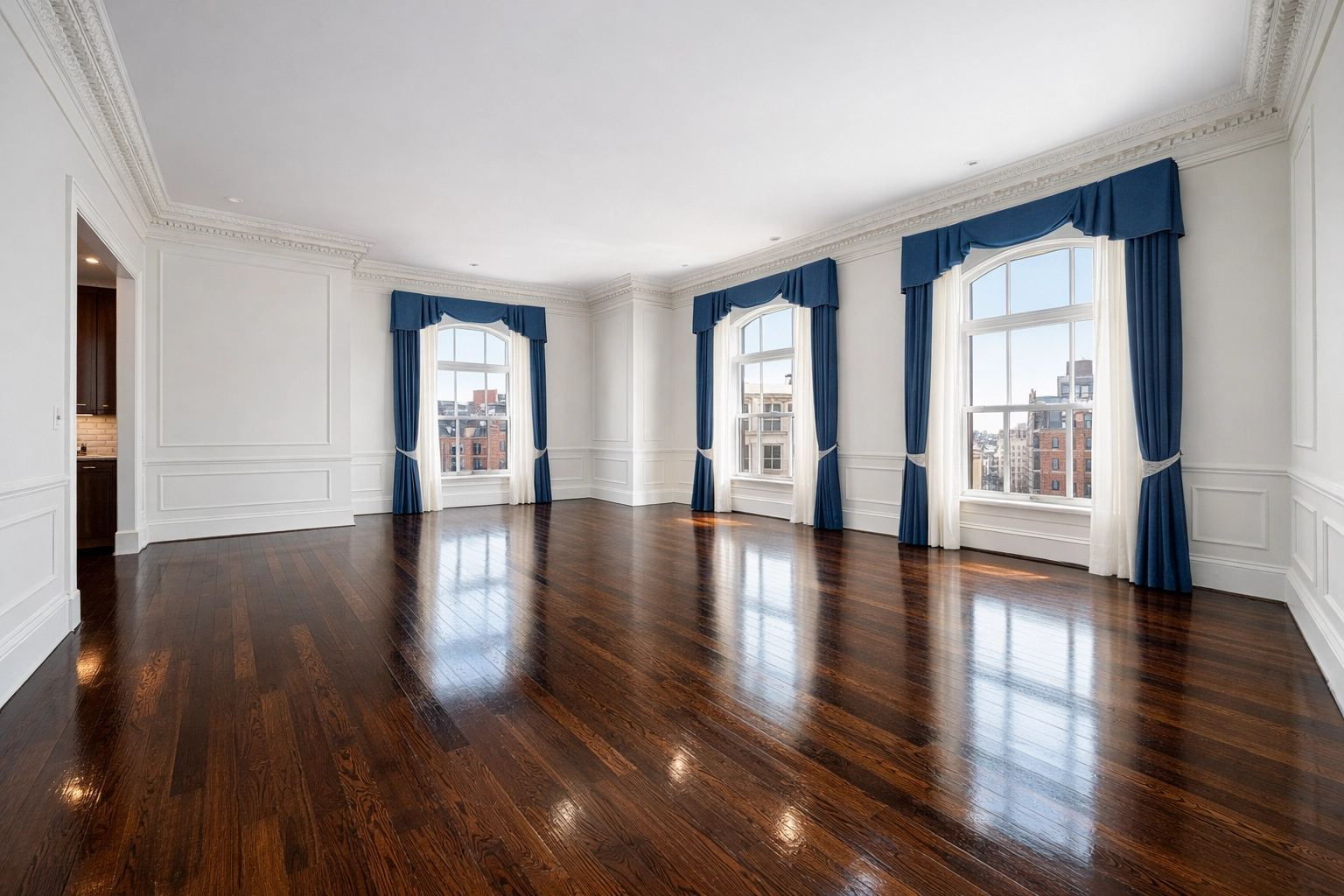 A spotless, sunlit living room with hardwood floors following a professional Boston apartment turnover.