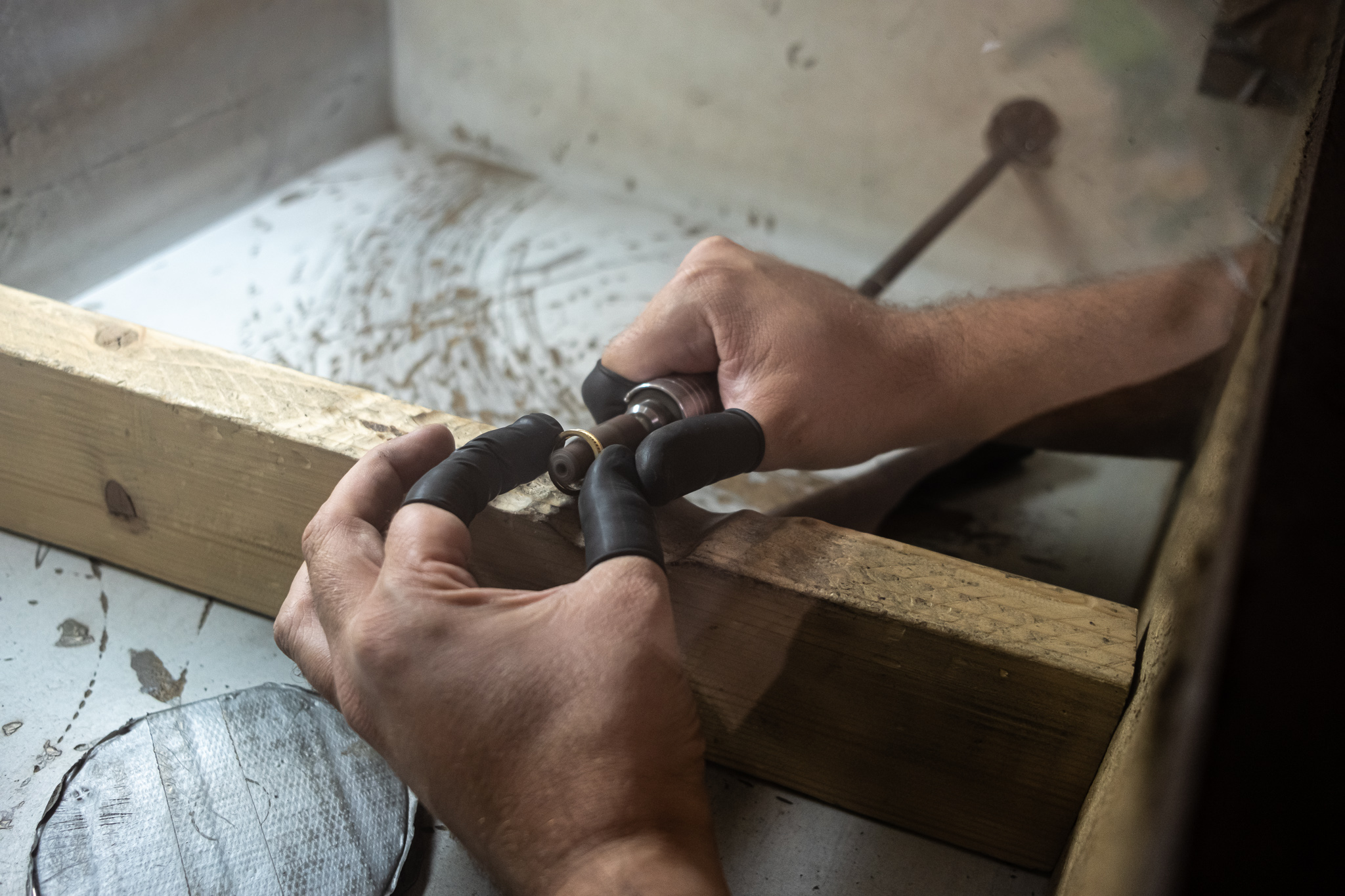 A jeweler polishes a ring at Atila