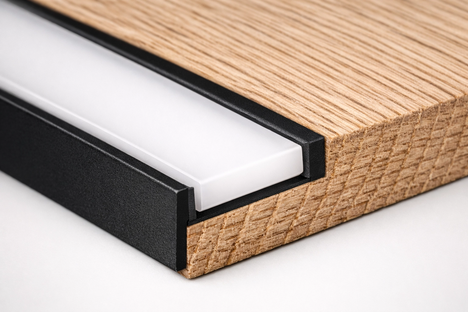Black aluminum LED profile recessed into a white oak shelf with a precision dado cut.