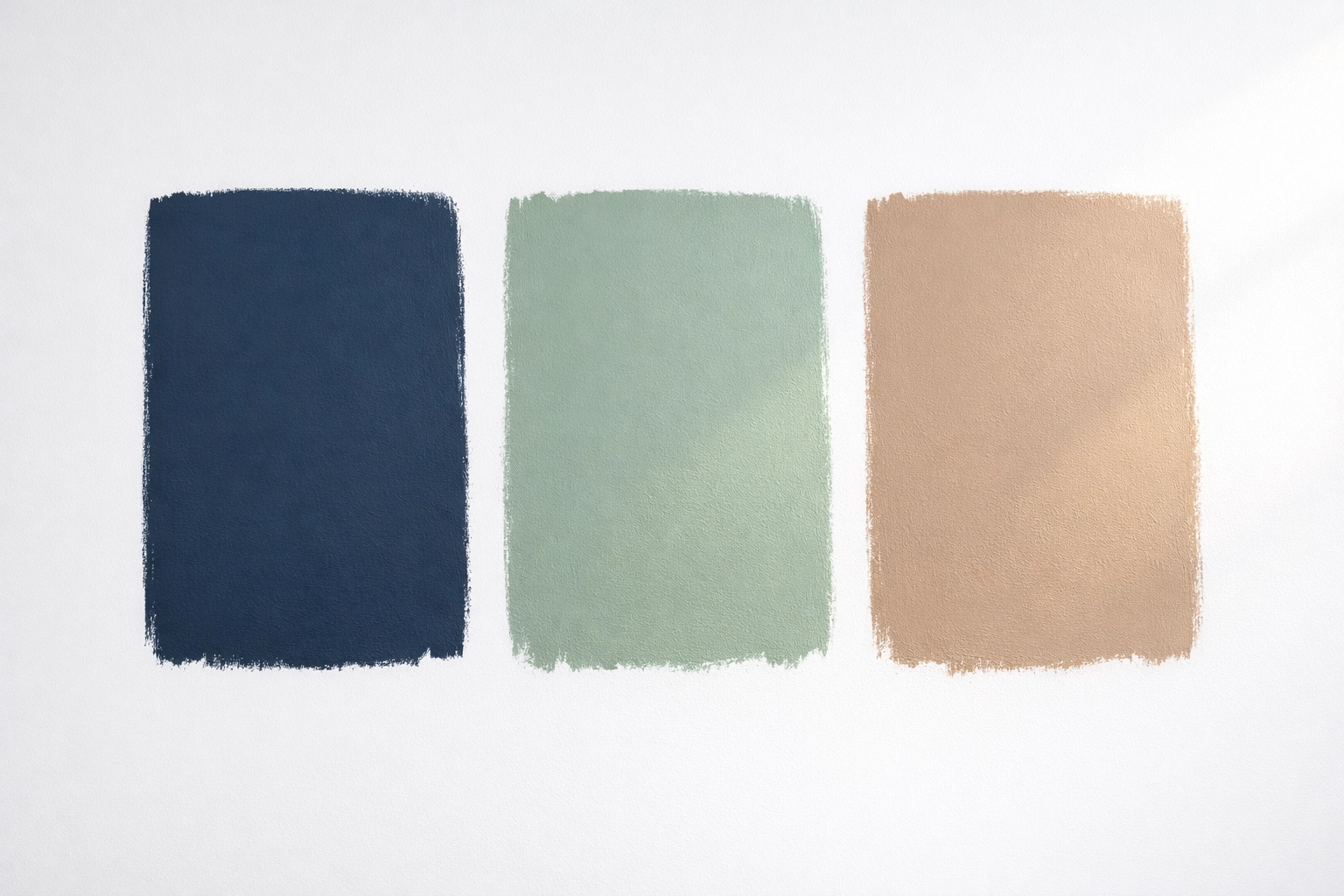 Paint swatches in navy, sage and taupe testing natural lighting for two-tone wall colour selection.