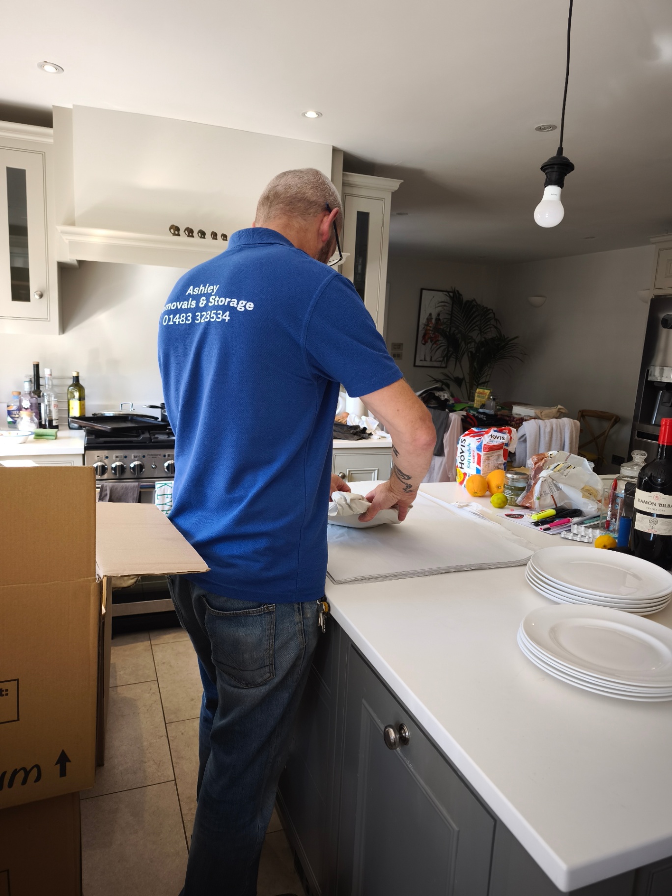 Ashley Removals team member wrapping kitchen plates