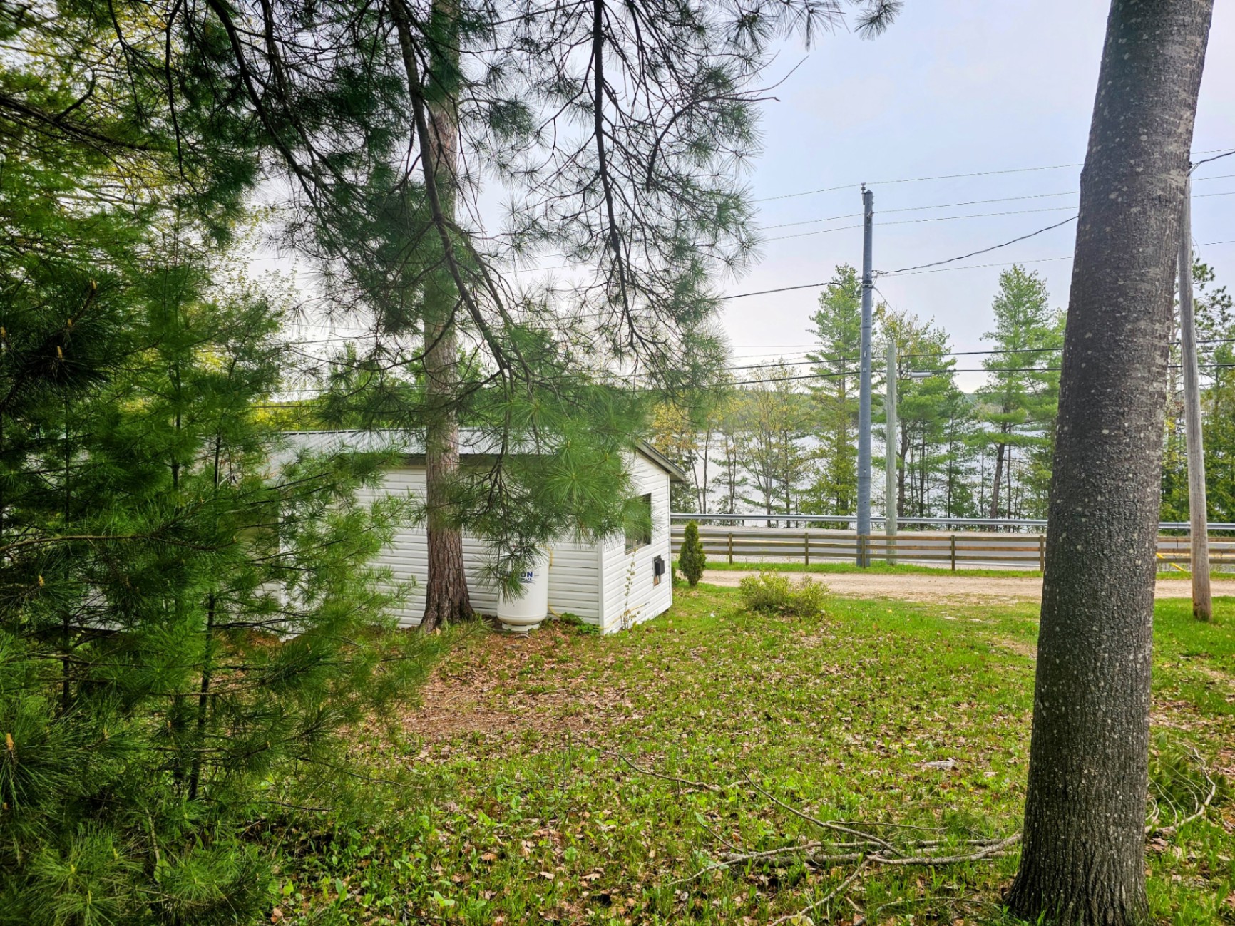 View of the lake from a cozy seasonal trailer site — Mazinaw Lakeside RV Park & Campground, real photo of the grounds