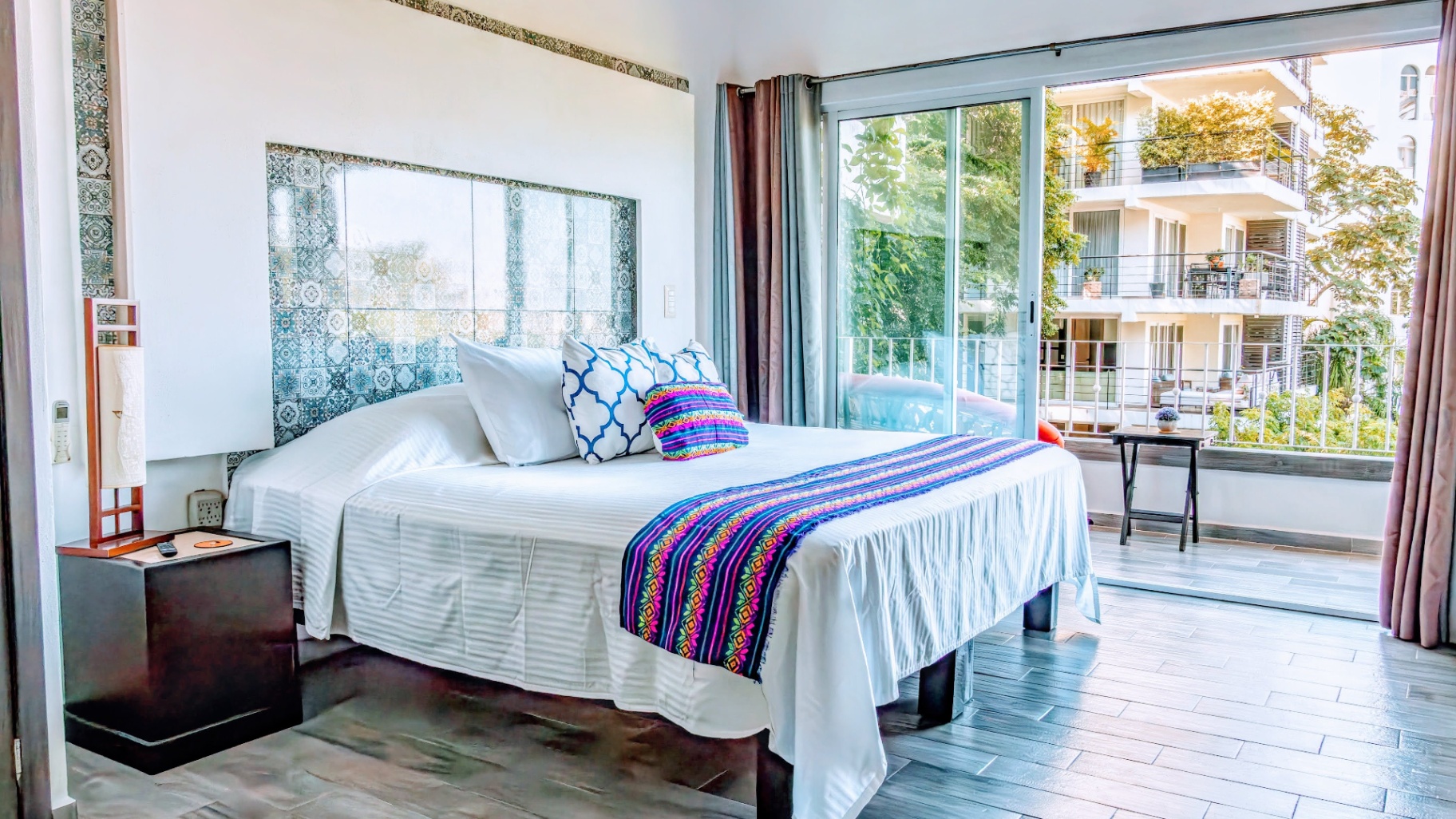 Bright, airy condo bedroom with artisan tile accents