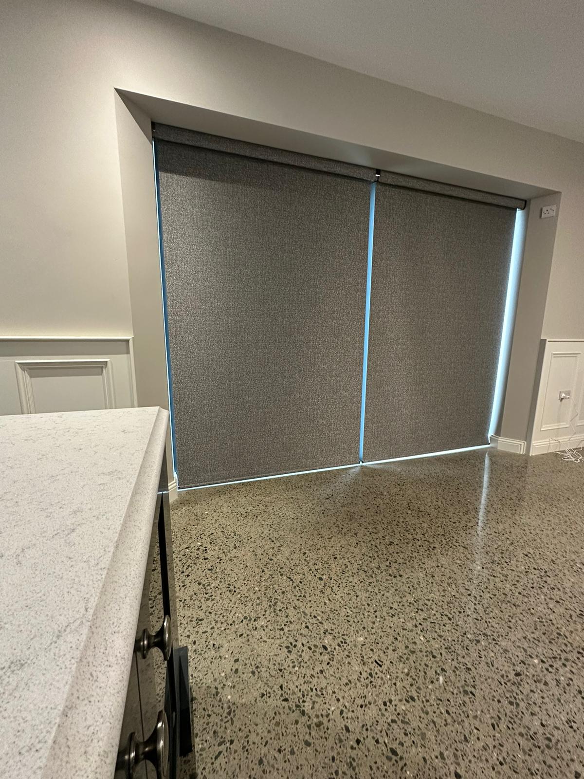 Floor-to-ceiling window treatments precisely fitted within a recessed window frame
