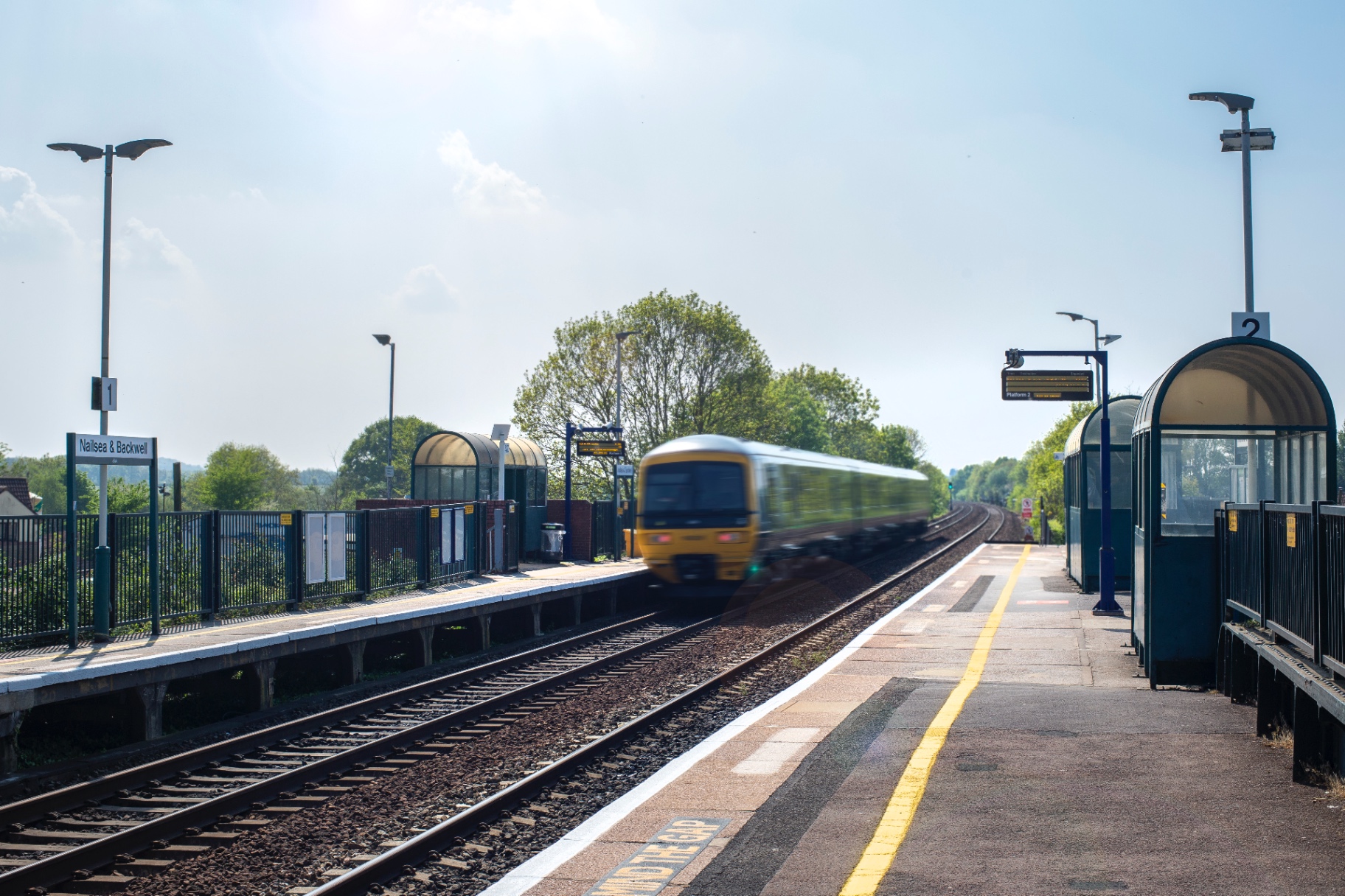 Nailsea & Backwell railway station Image shows Nailsea & Backwell railway station with a train arriving, highlighting excellent transport links for residents commuting to Bristol, Bath, and beyond. The clean, well-maintained platforms reinforce the village's appeal for buyers and renters seeking convenience living in North Somerset with easy access to mainline rail services.