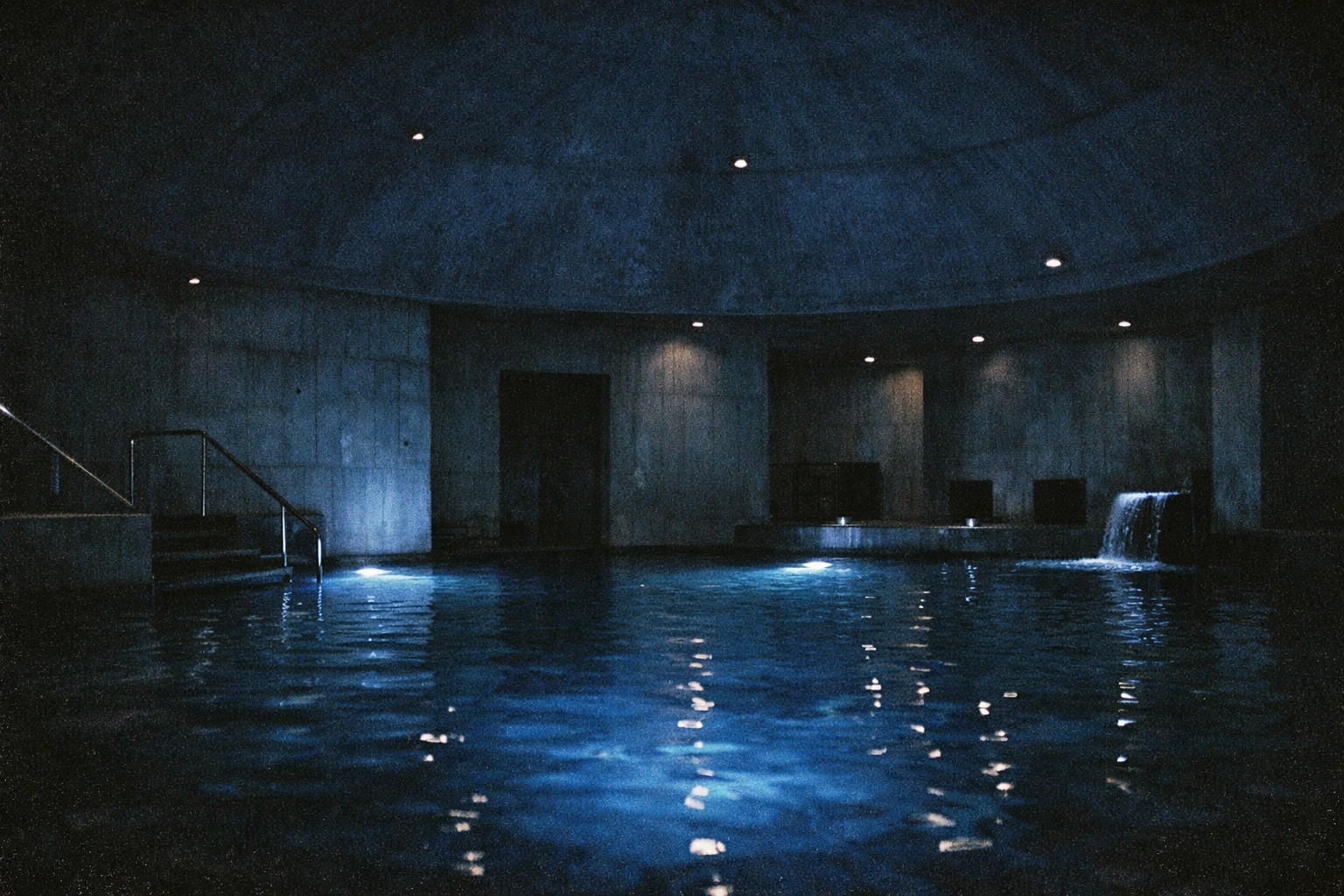A dark domed pool with blue reflections, minimal brutalist architecture, shot like grainy 35mm film—Liquidrom vibes.