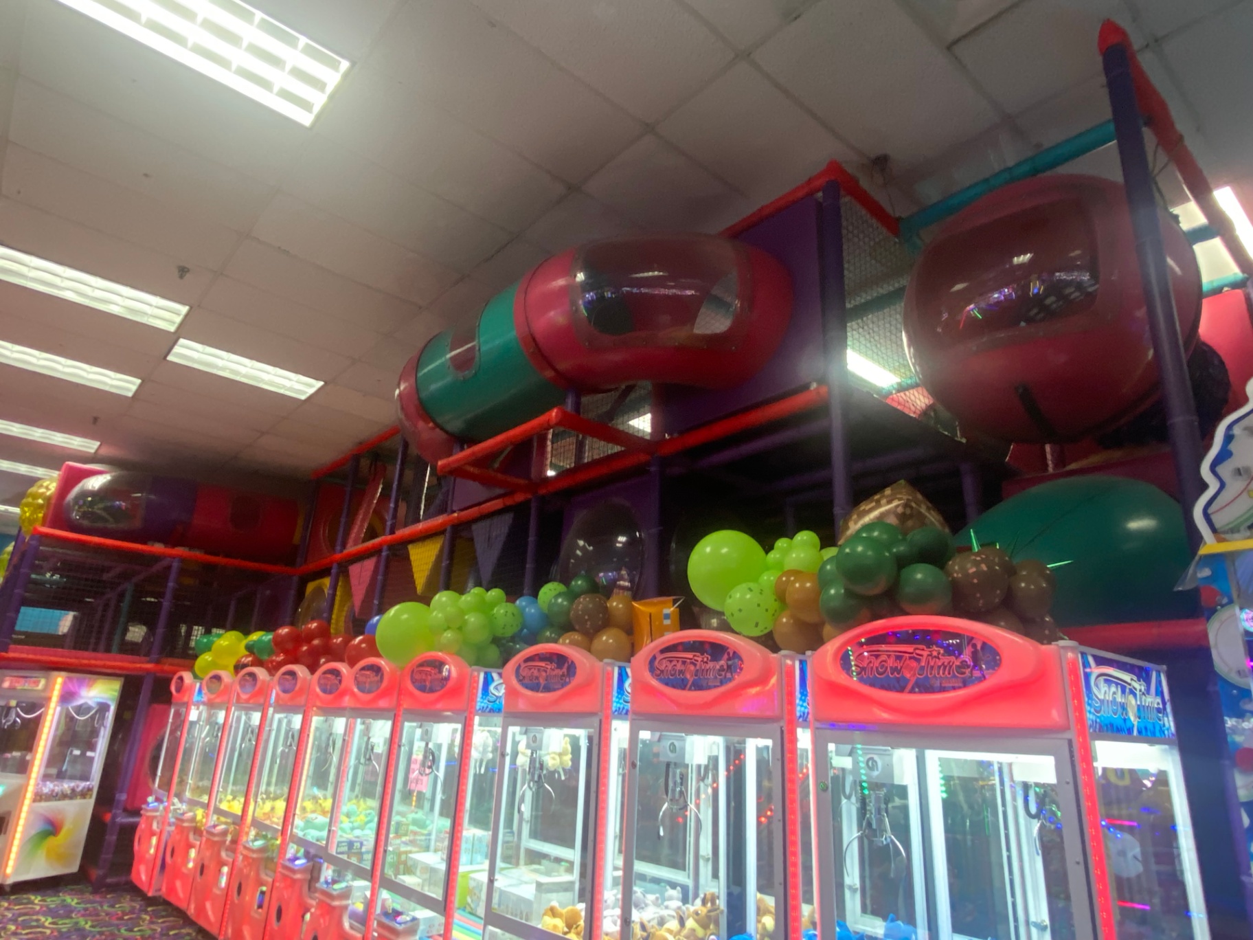 Jungle gym attraction area with claw machines at Funstation USA.