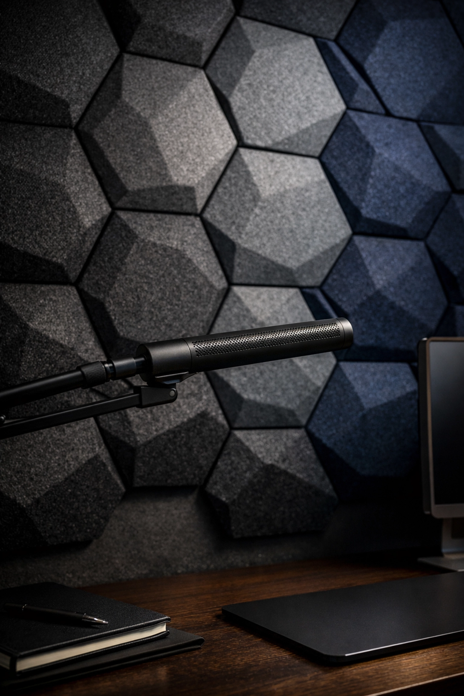 Hexagonal acoustic wall panels and a professional beamforming microphone for high-quality audio in a small studio.