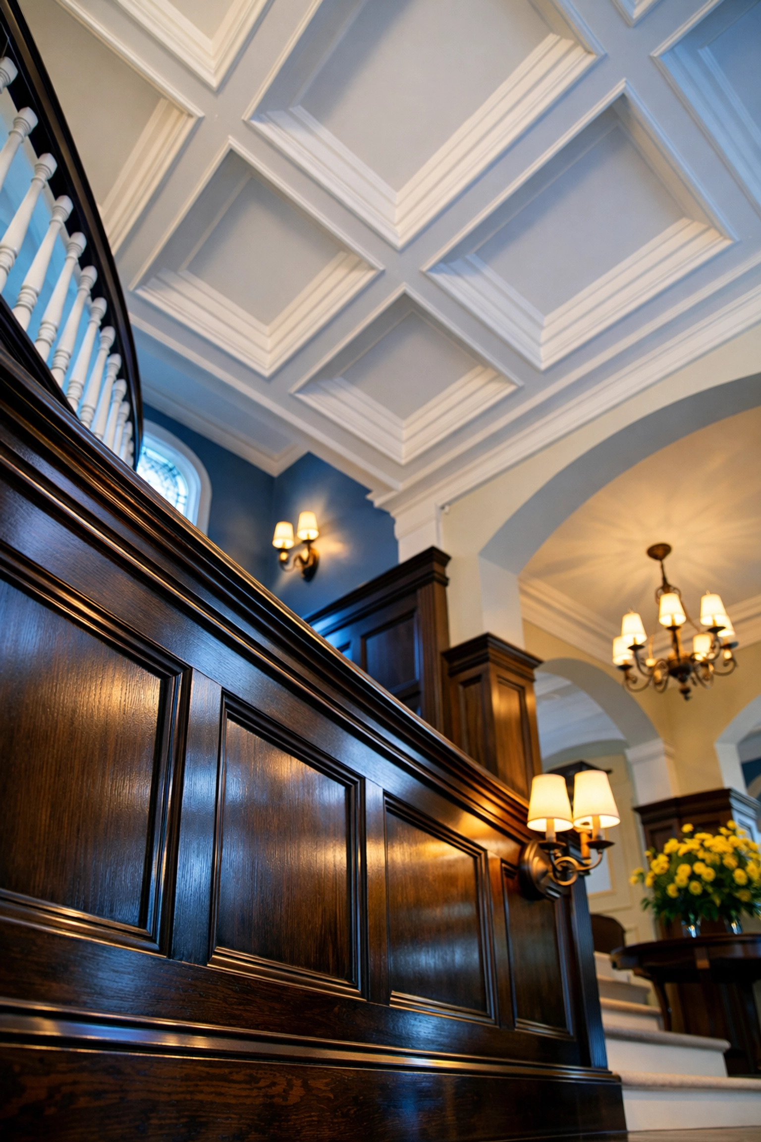 Impeccably cleaned wood wainscoting and coffered ceilings in a historic Newton Tudor estate foyer.