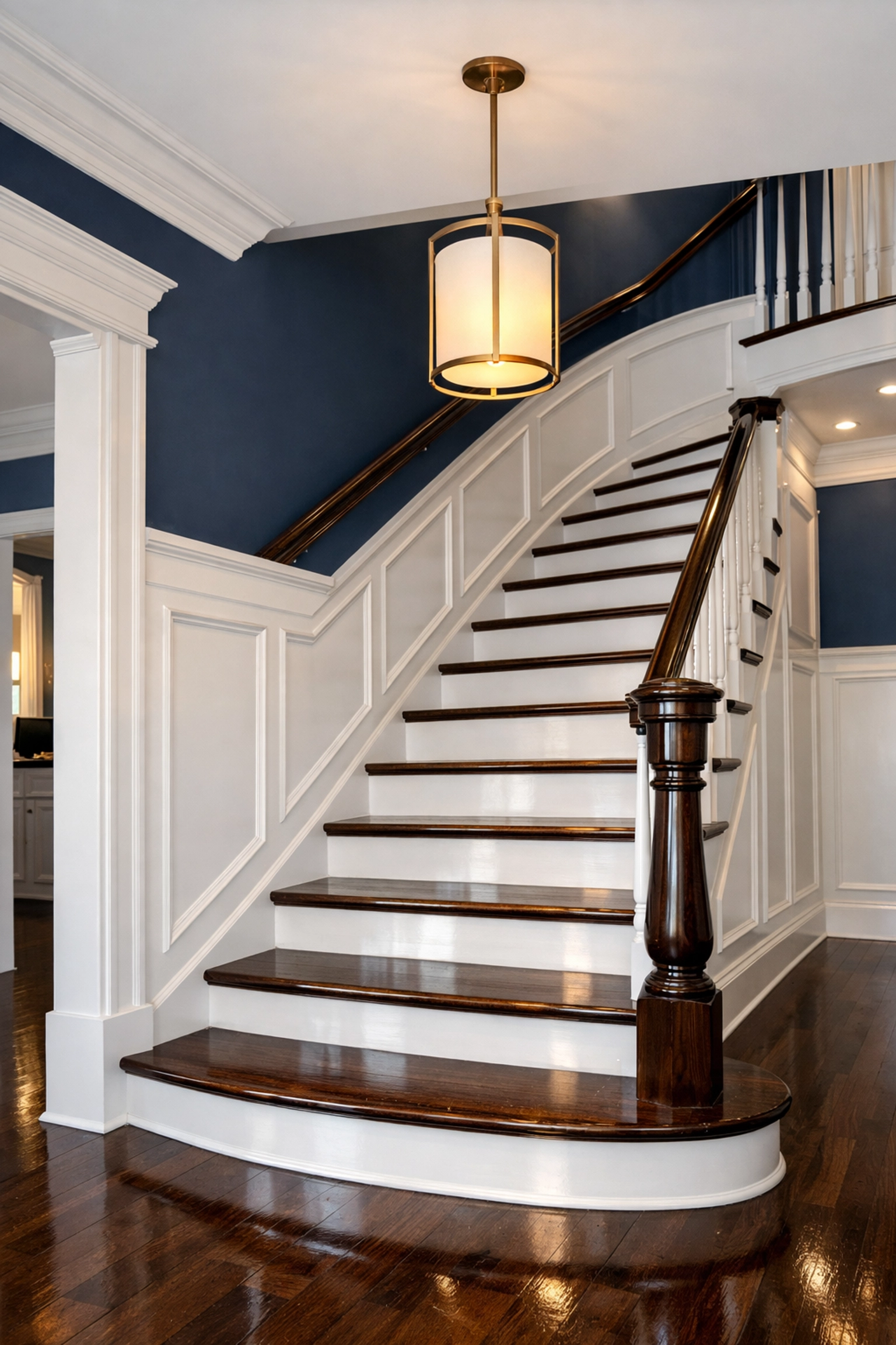 Spotless luxury foyer and polished hardwood stairs illustrating the value of professional house cleaning.