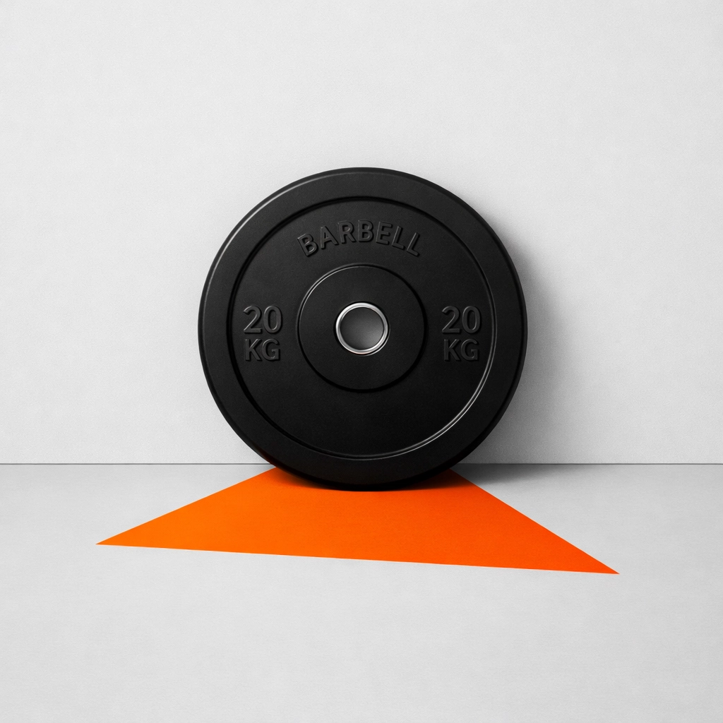 A black Olympic weight plate representing explosive power and focus achieved through pre-workout breathwork techniques.