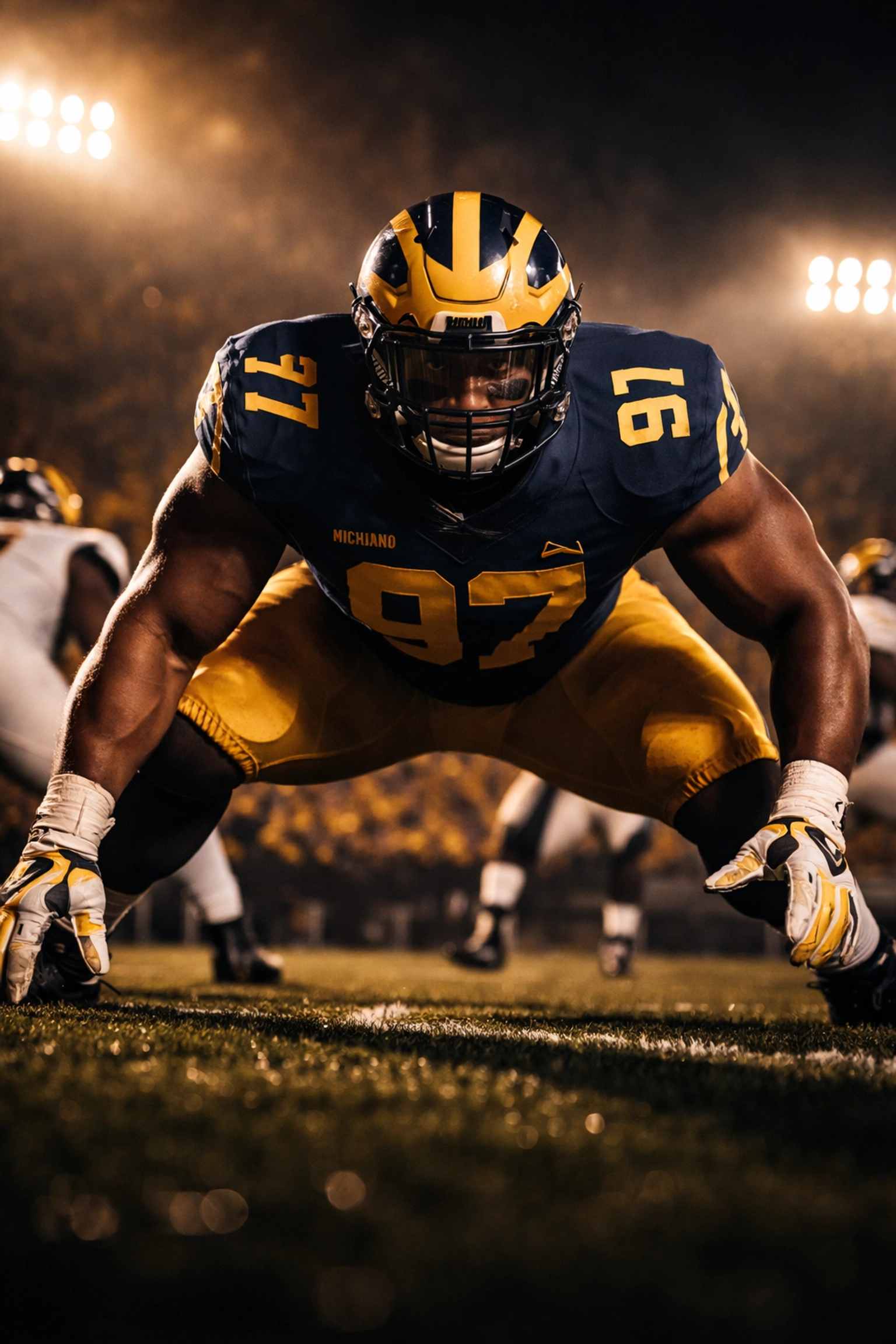 College football defensive lineman in Michigan uniform in three-point stance, highlighting top transfer Enow Etta.