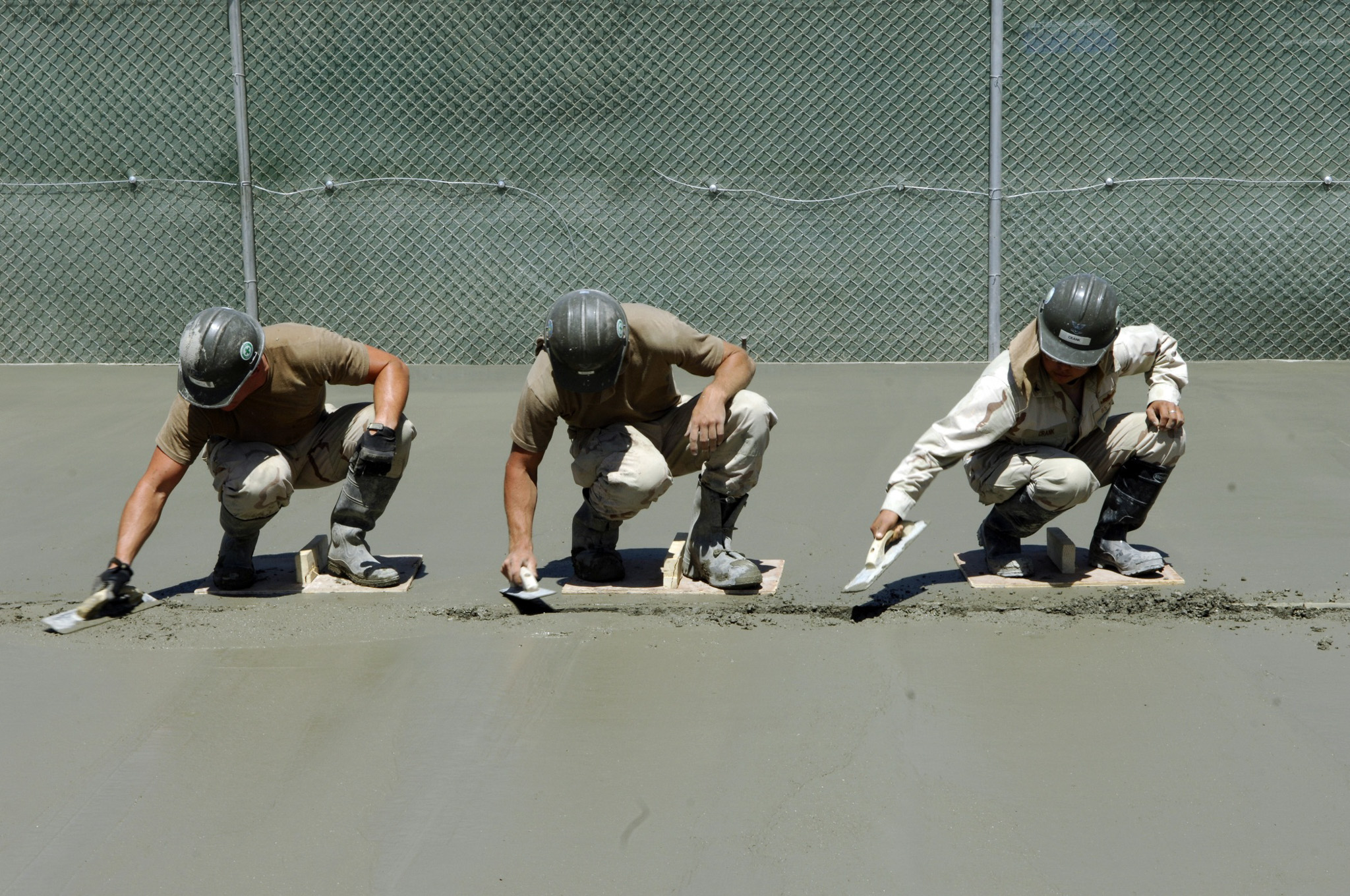 Construction Workers Smoothing Concrete