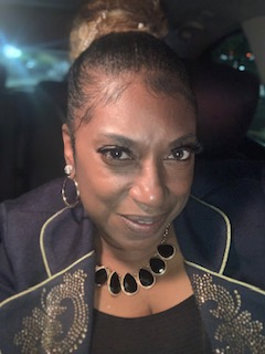A confident woman in business attire in a well-lit car