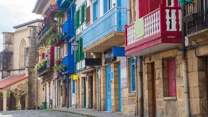A colorful row of traditional Basque-style houses with vibrant balconies