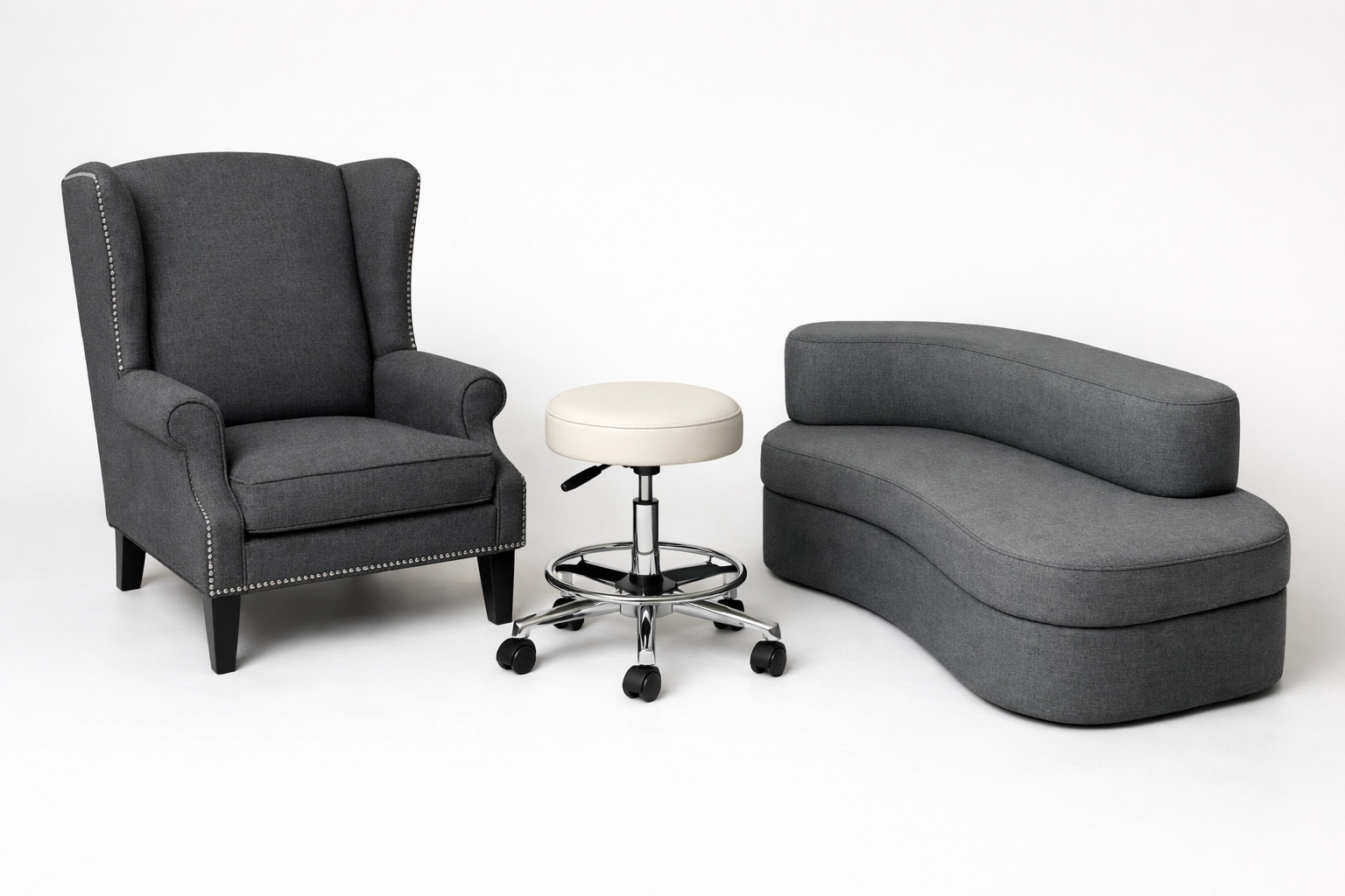 Collection of custom upholstered furniture including a wingback chair and medical stool.