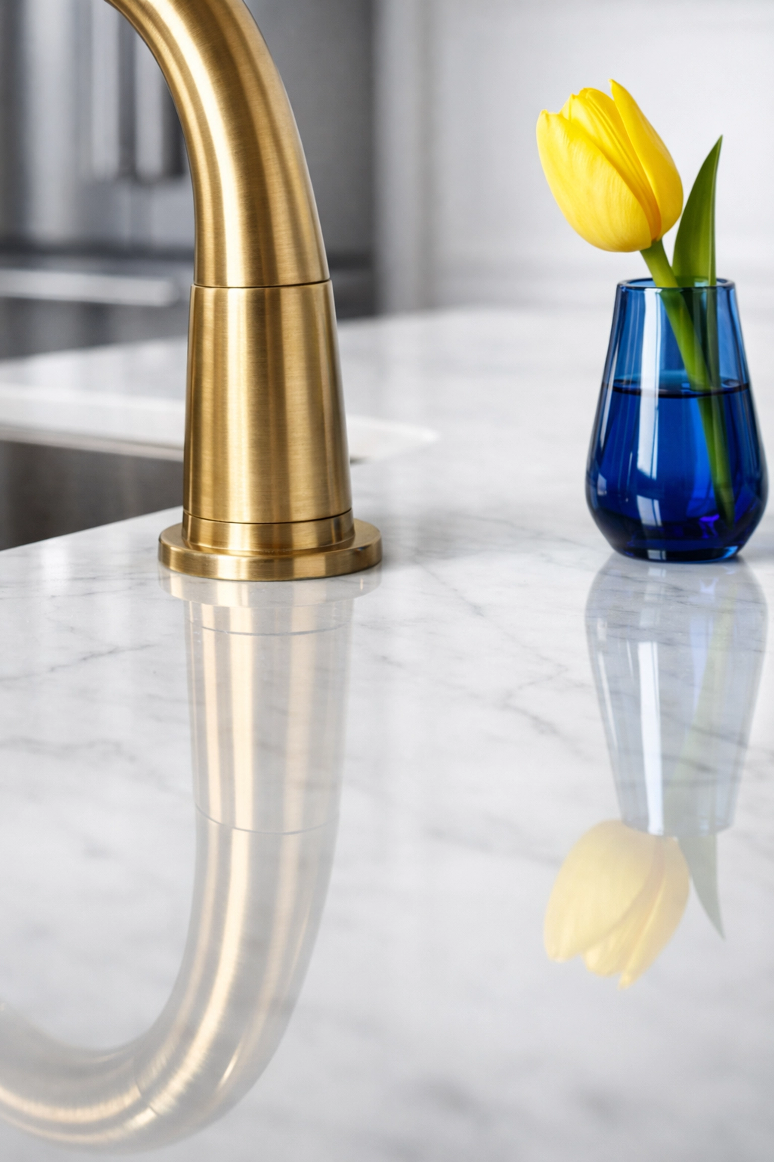 Pristine white marble kitchen island showing the benefits of gentle green cleaning products.
