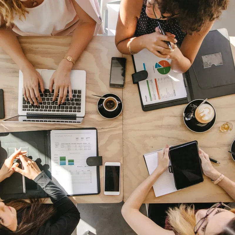 Overhead view of a team collaborating on a marketing plan with data charts