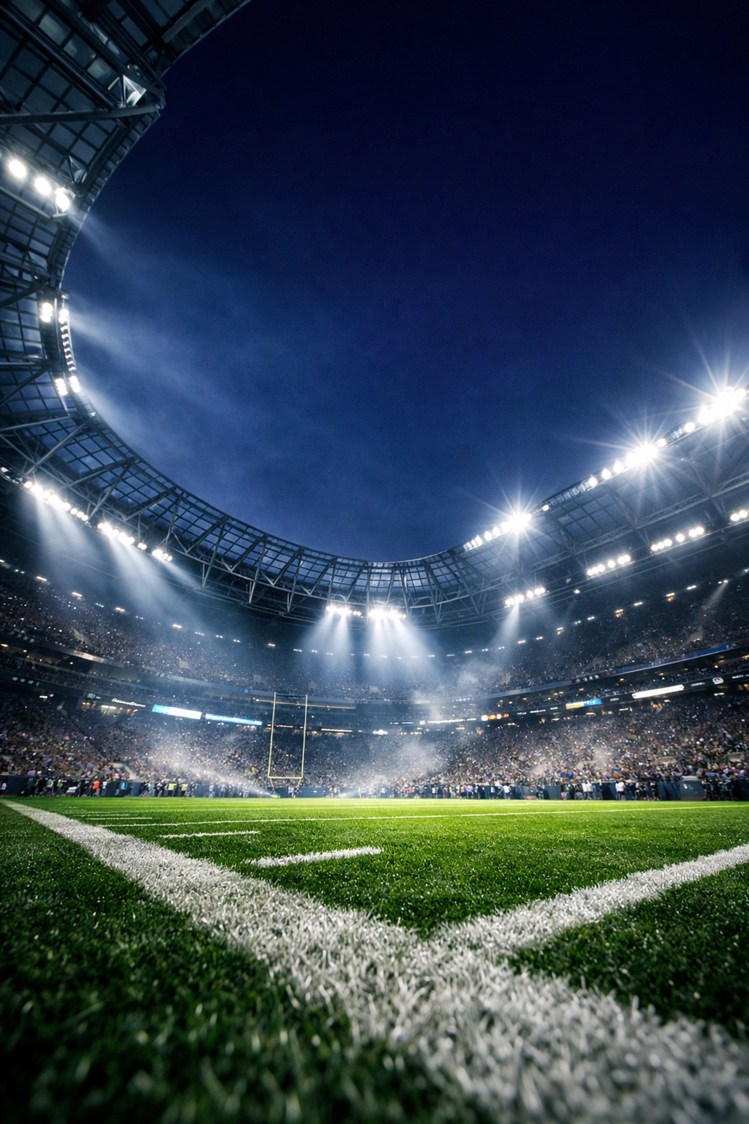 A massive illuminated football stadium at night representing high-stakes Super Bowl advertising investments.