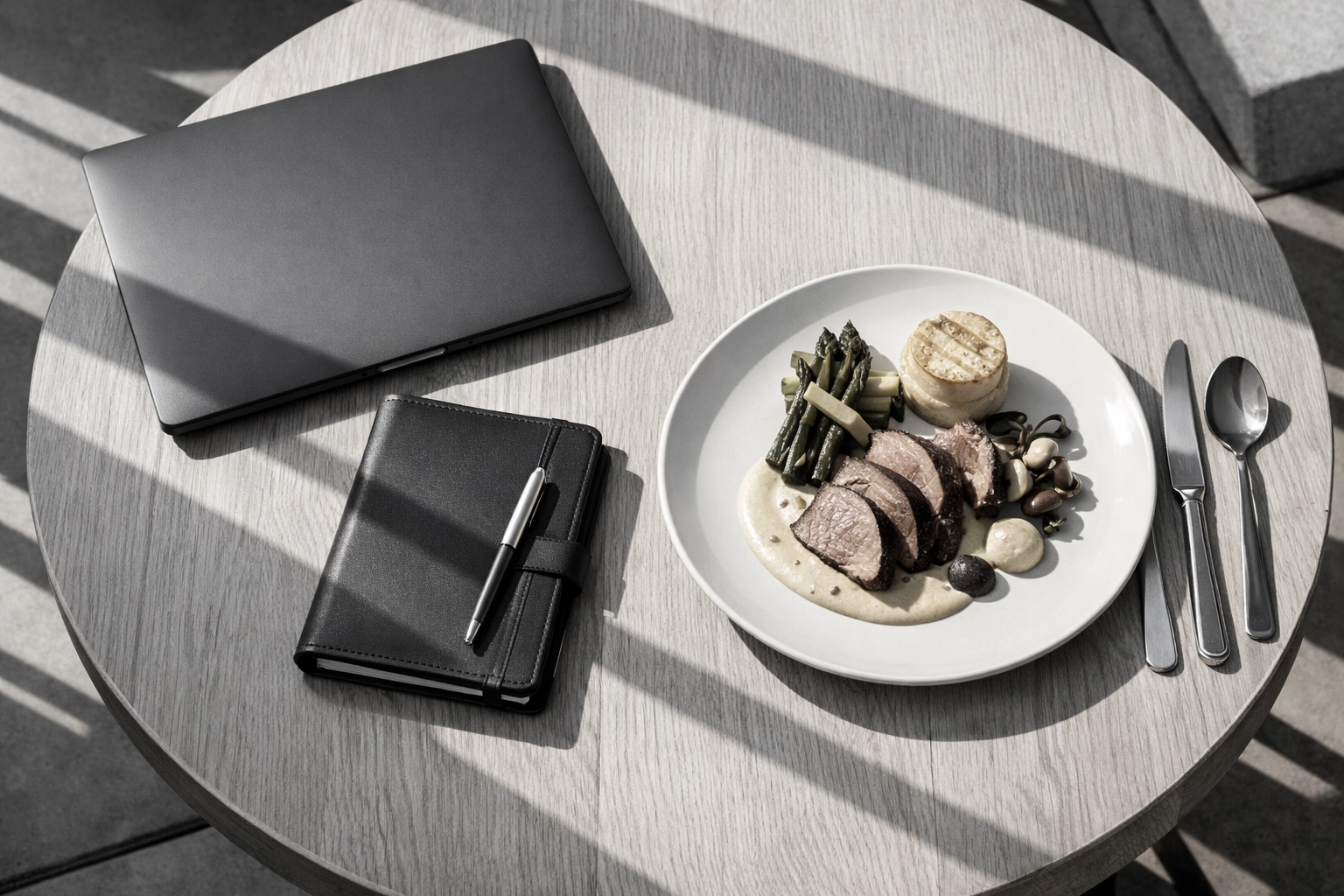 Digital nomad working lunch with a laptop and gourmet meal at a Steamboat Springs monthly rental.