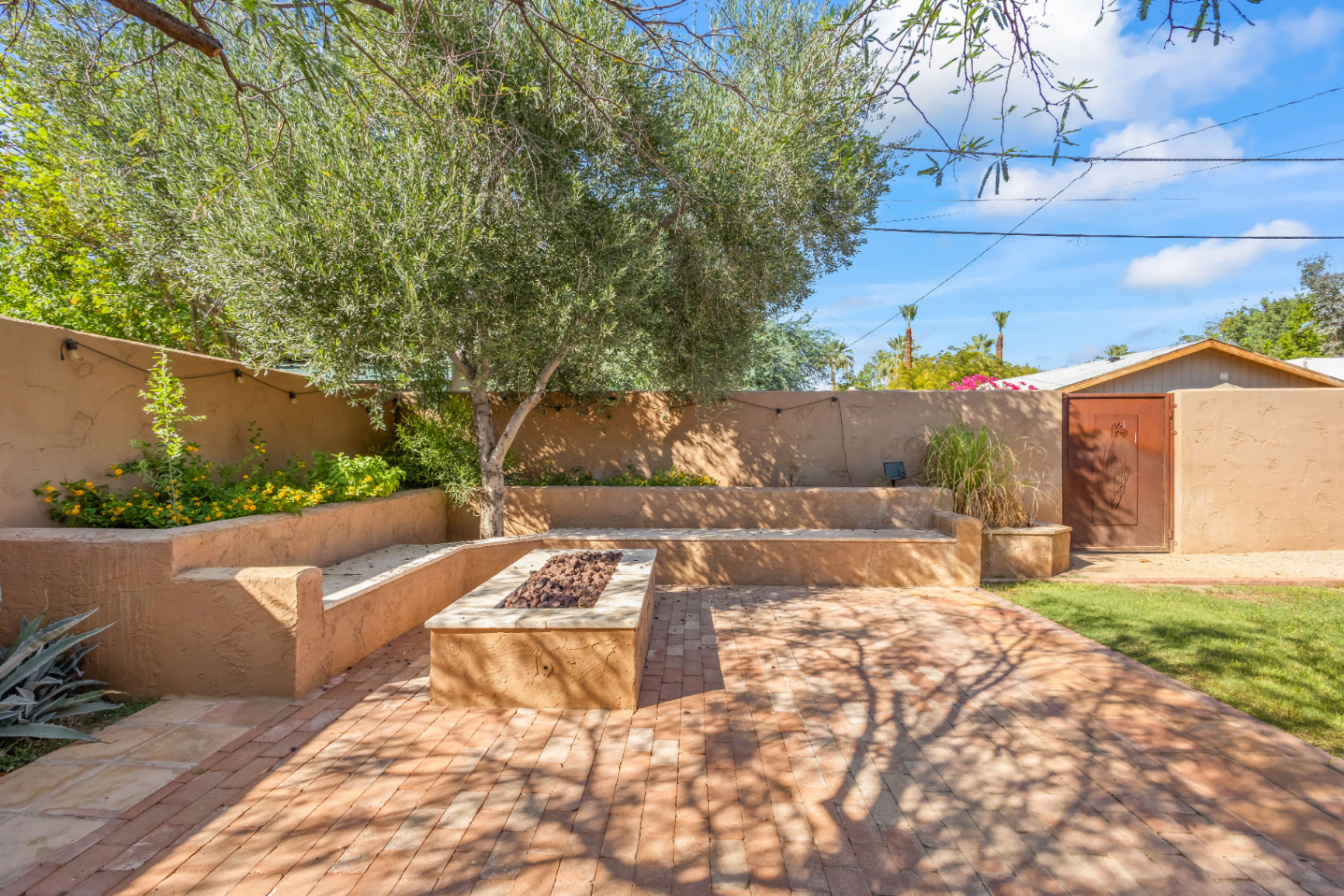 Aerial view of a luxury Phoenix home with pool, desert landscaping, and mountains, showcasing real estate drone photography benefits.